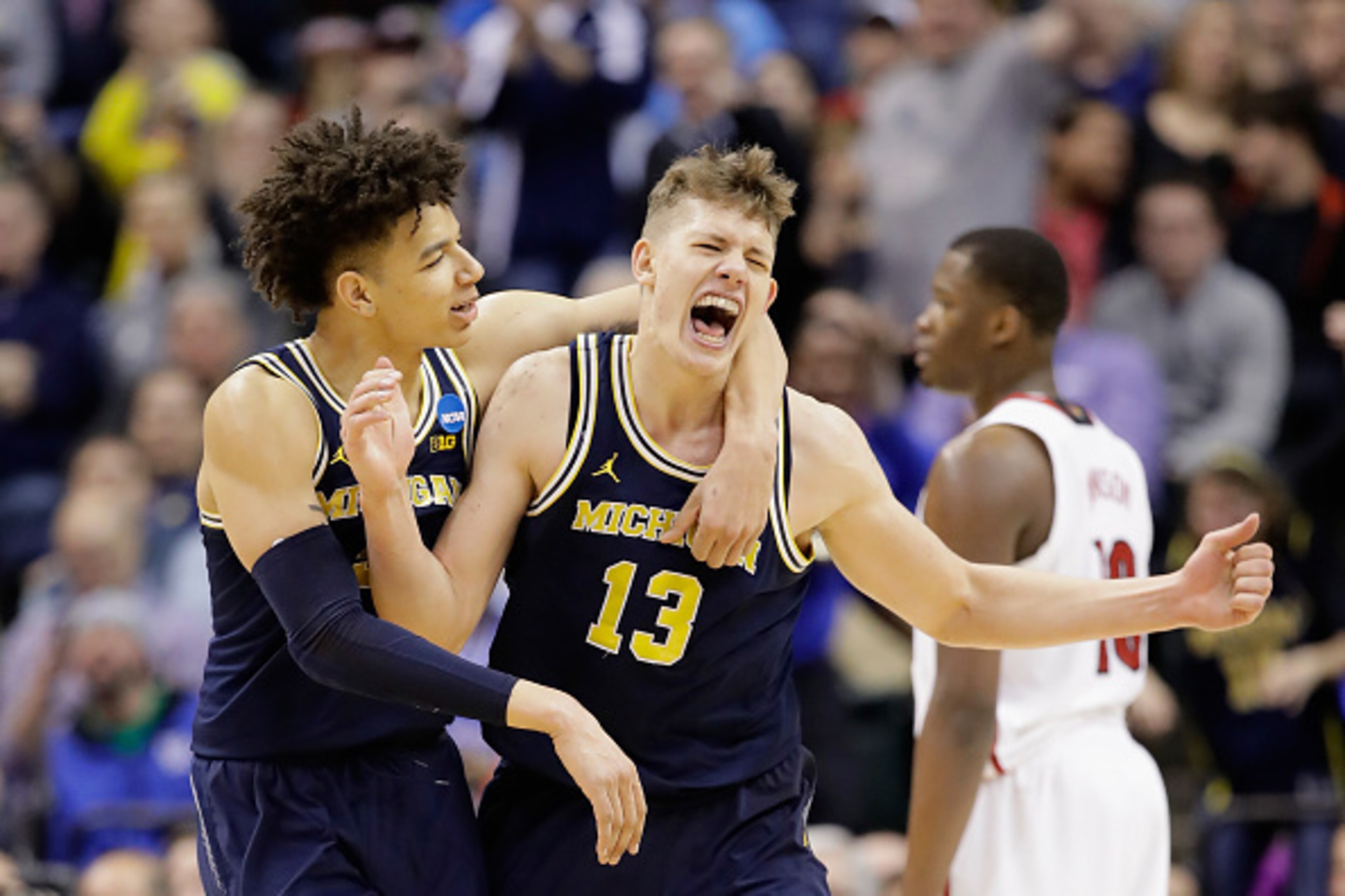 INDIANAPOLIS, IN - MARCH 19: Moritz Wagner #13 of the Michigan Wolverines celebrates a shot with D.J. Wilson #5 in the second half against the Louisville Cardinals during the second round of the 2017 NCAA Men's Basketball Tournament at the Bankers Life F INDIANAPOLIS, IN - MARCH 19: Moritz Wagner #13 of the Michigan Wolverines celebrates a shot with D.J. Wilson #5 in the second half against the Louisville Cardinals during the second round of the 2017 NCAA Men's Basketball Tournament at the Bankers Life F