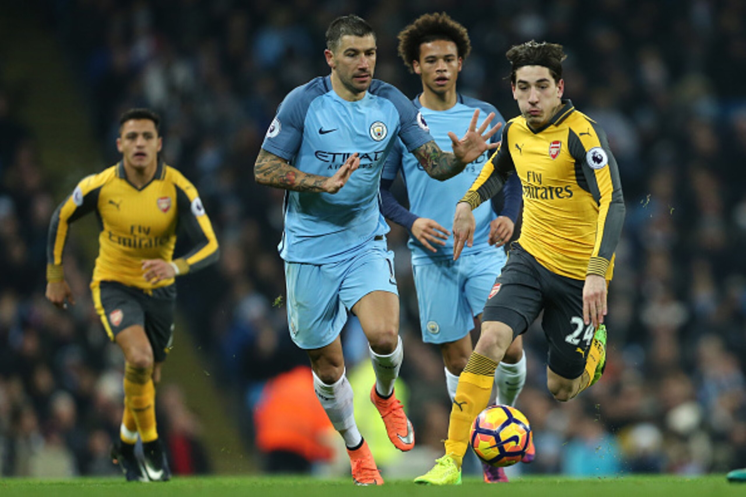 MANCHESTER, ENGLAND - DECEMBER 18: Aleksandar Kolarov of Manchester City and Hector Bellerin of Arsenal during the Premier League match between Manchester City and Arsenal at Etihad Stadium on December 18, 2016 in Manchester, England. (Photo by James Bayl