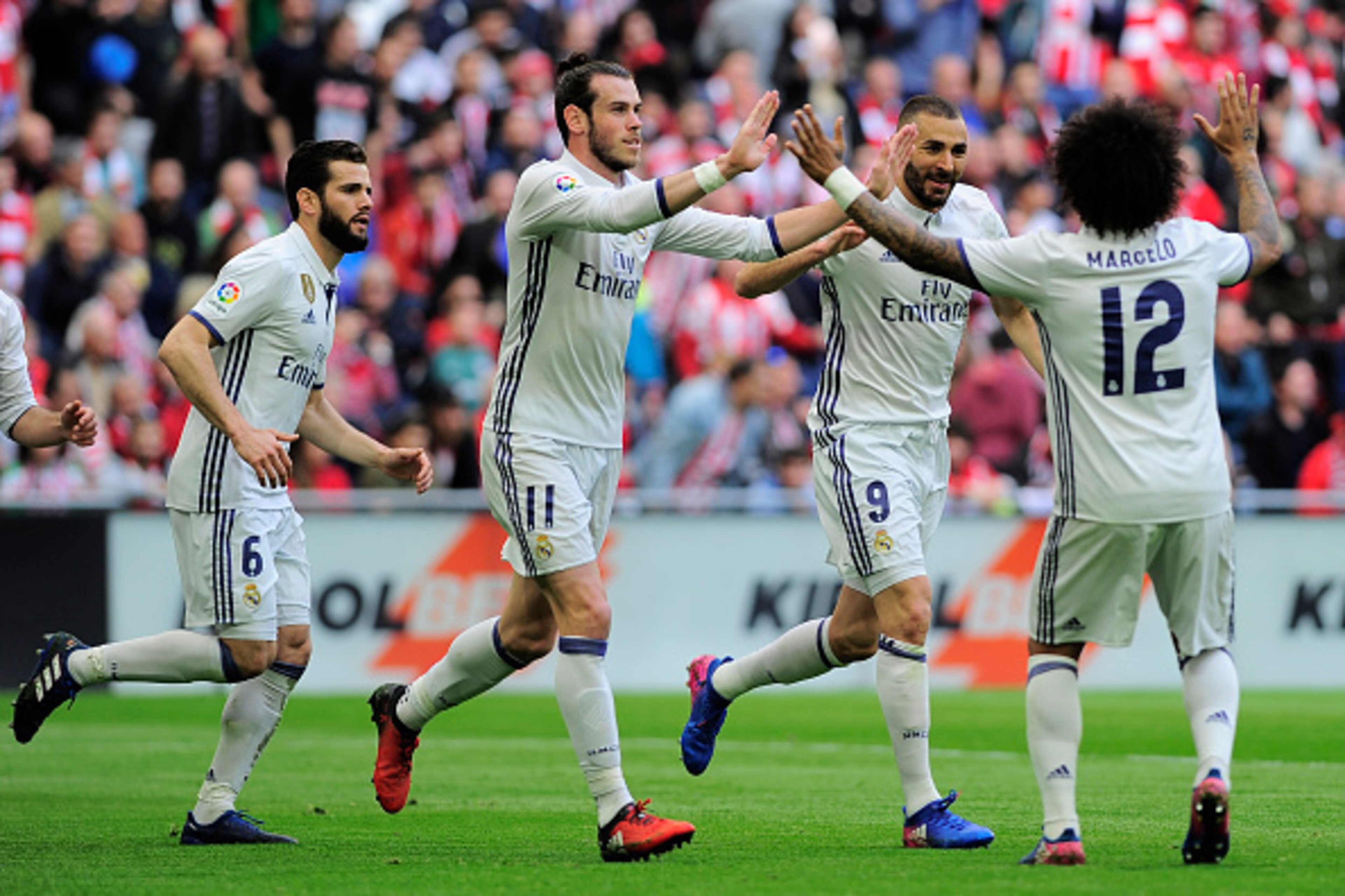 Real Madrid's players celebrate after French forward Karim Benzema (2R)scored their team's first goal during the Spanish league football match Athletic Club Bilbao vs Real Madrid CF at the San Mames stadium in Bilbao on March 18, 2017. / AFP PHOTO / ANDER