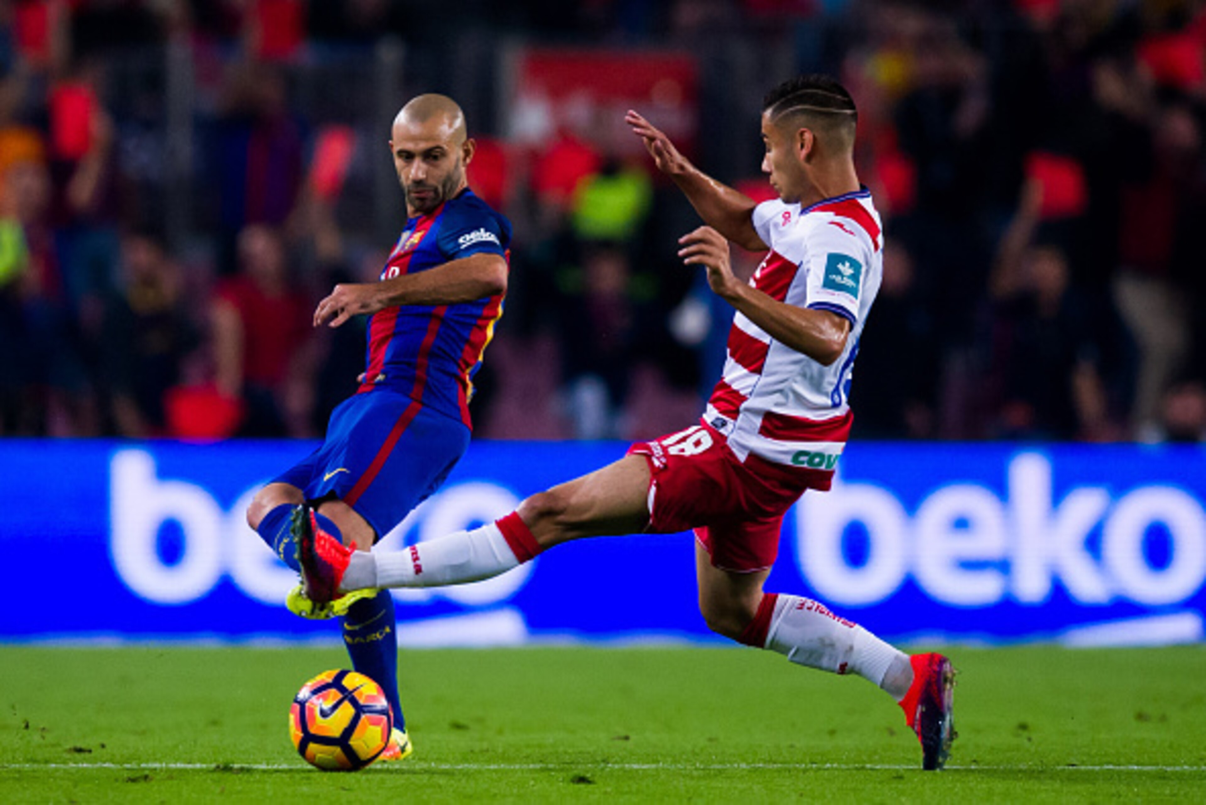 BARCELONA, SPAIN - OCTOBER 29: Javier Mascherano (L) of FC Barcelona plays the ball past Andreas Pereira of Granada CF during the La Liga match between FC Barcelona and Granada CF at Camp Nou stadium on October 29, 2016 in Barcelona, Spain. (Photo by Alex