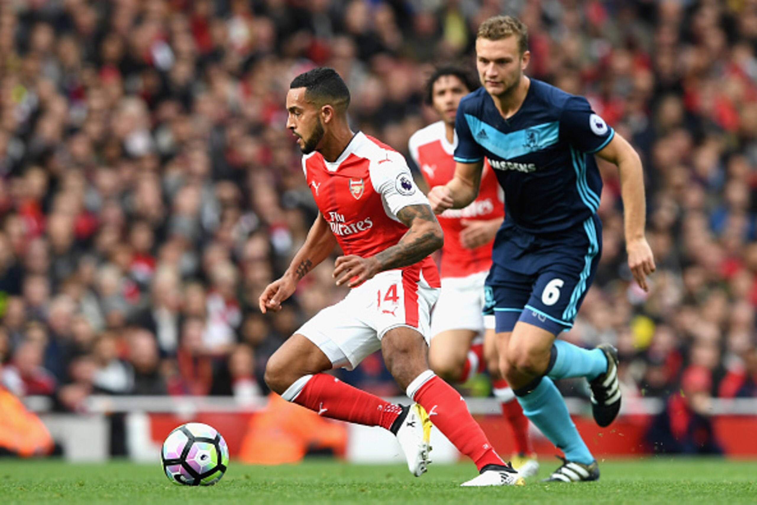LONDON, ENGLAND - OCTOBER 22:  Theo Walcott of Arsenal (L) is chased by Ben Gibson of Middlesbrough (R) during the Premier League match between Arsenal and Middlesbrough at the Emirates Stadium on October 22, 2016 in London, England.  (Photo by Shaun Bott