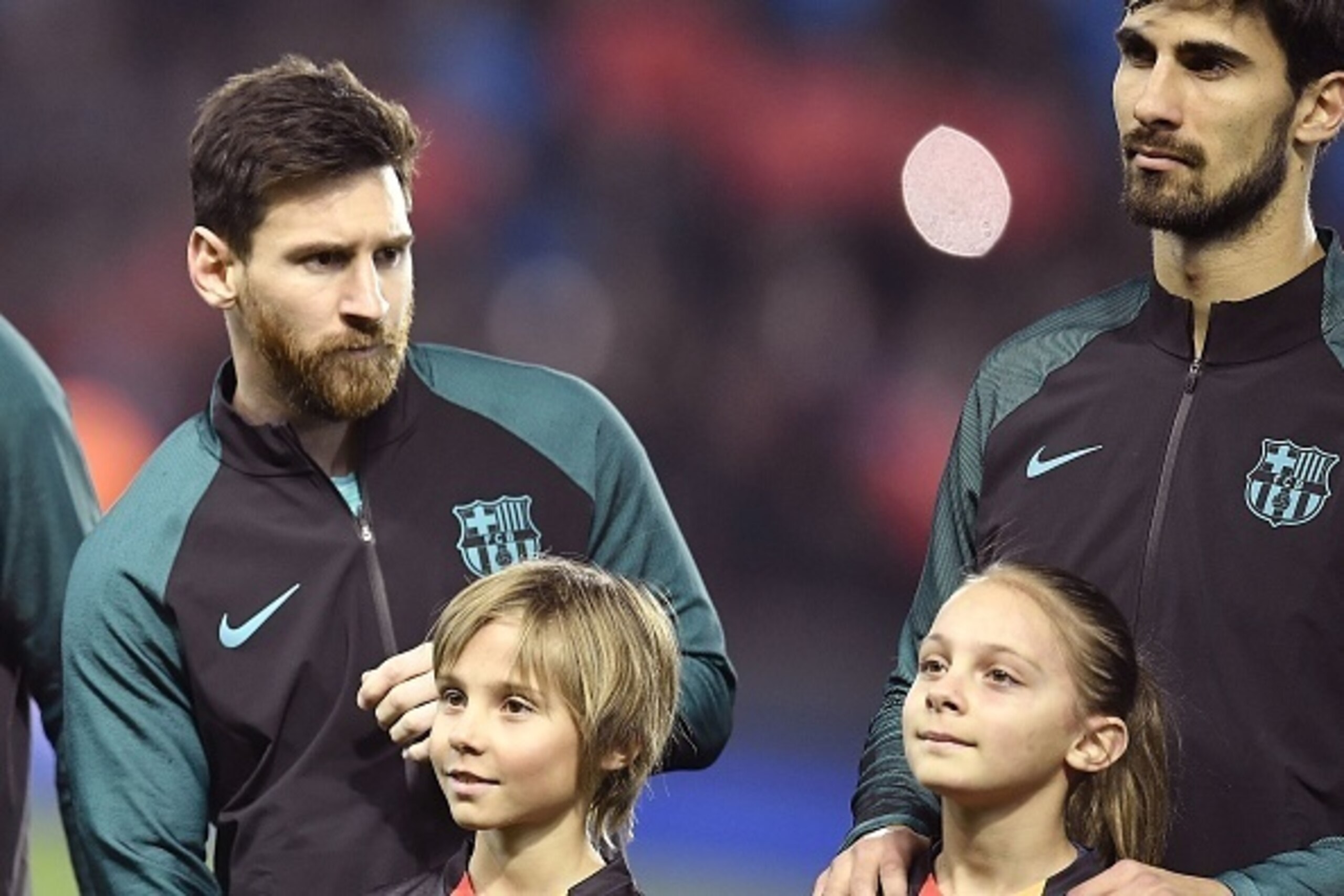 Barcelona's Argentinian forward Lionel Messi (L) and Barcelona's Portuguese midfielder Andre Gomes pose prior to the UEFA Champions League round of 16 first leg football match between Paris Saint-Germain and FC Barcelona on February 14, 2017 at the Parc d