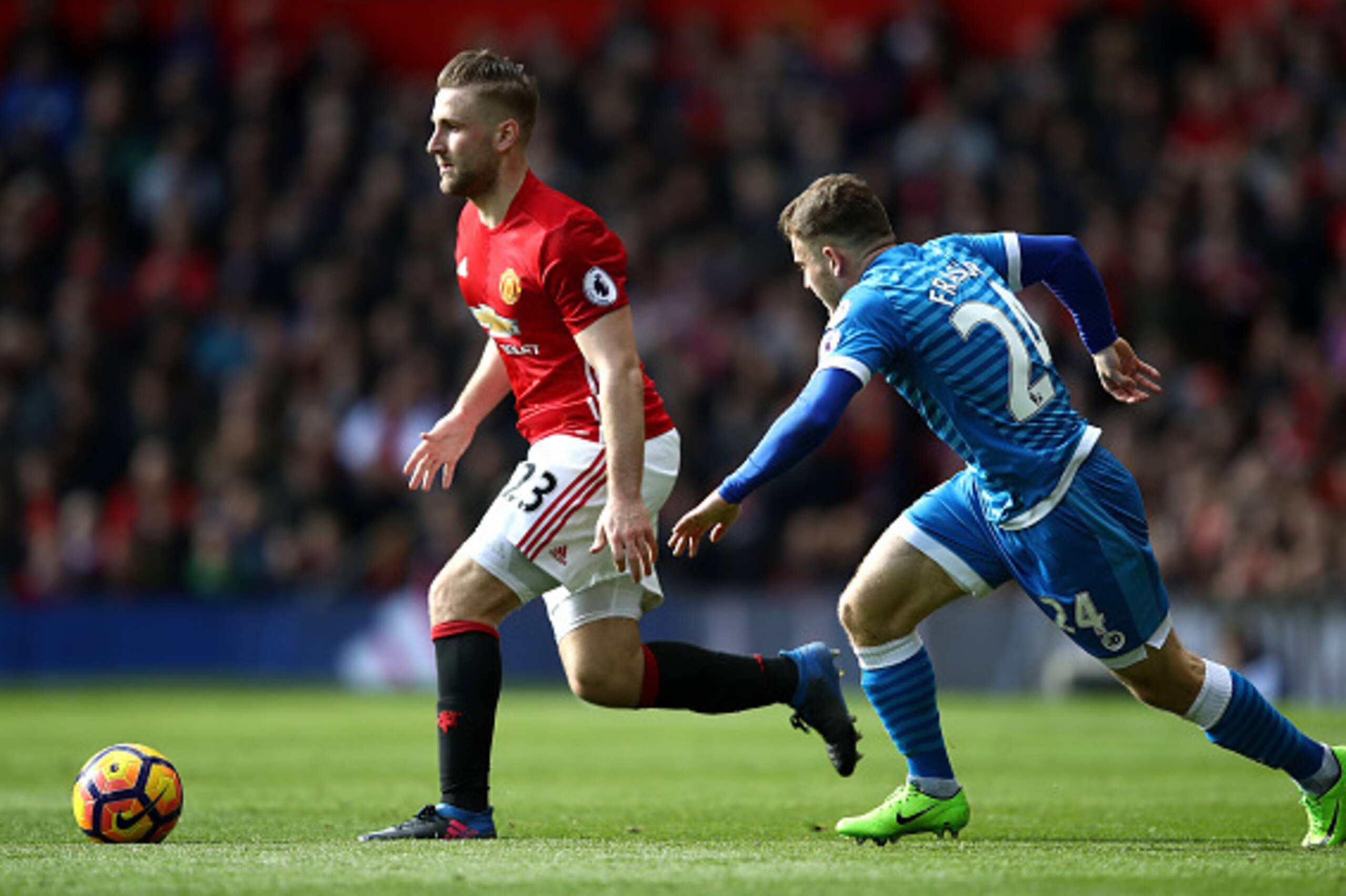 MANCHESTER, ENGLAND - MARCH 04: Luke Shaw of Manchester United (L) attempts to take the ball past Ryan Fraser of AFC Bournemouth (R) during the Premier League match between Manchester United and AFC Bournemouth at Old Trafford on March 4, 2017 in Manchest