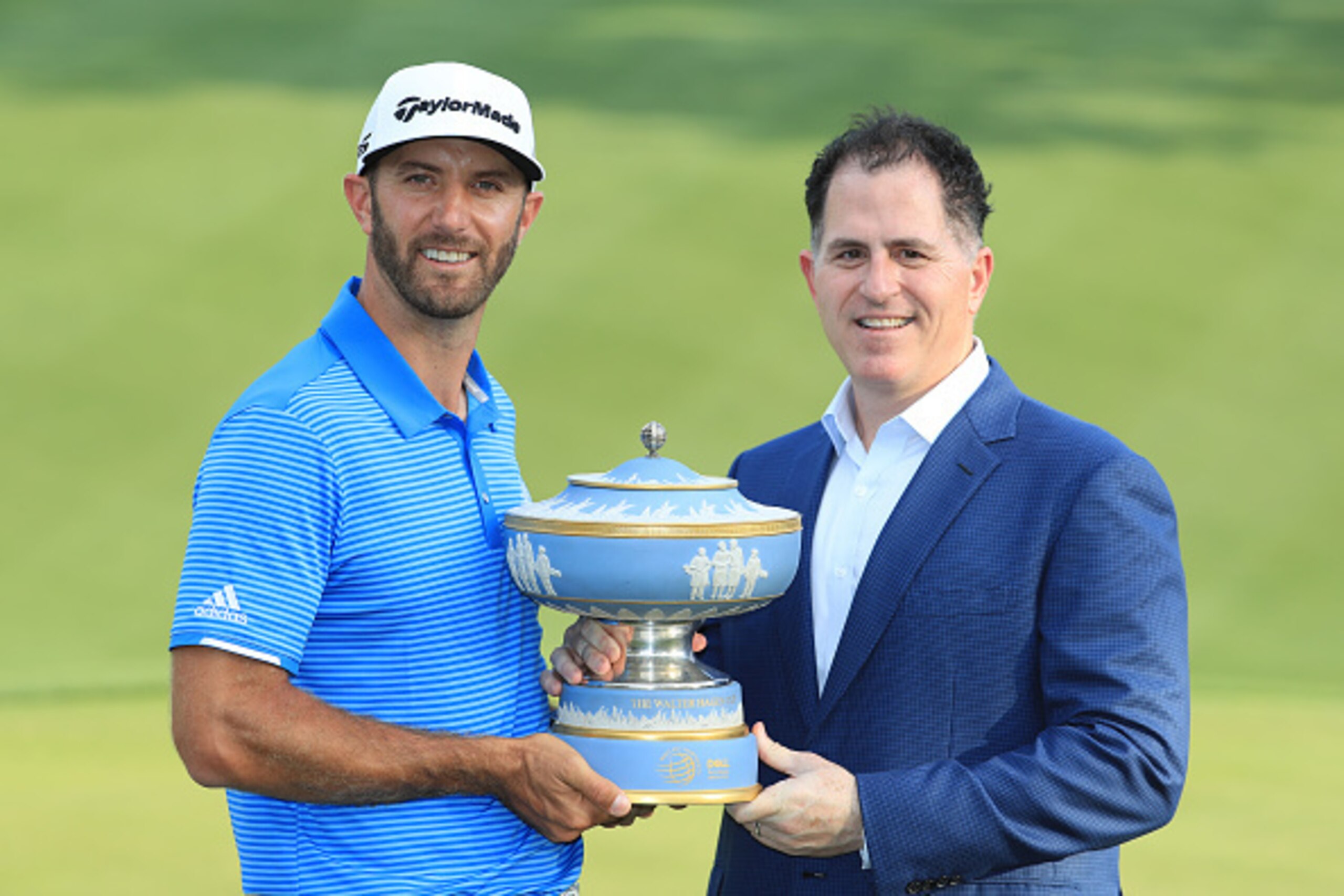AUSTIN, TX - MARCH 26:  Dustin Johnson of the USA is presented with the trophy by Michael Dell, Chairman and CEO of Dell Technologies, after winning the World Golf Championships-Dell Technologies Match Play at the Austin Country Club on March 26, 2017 in 