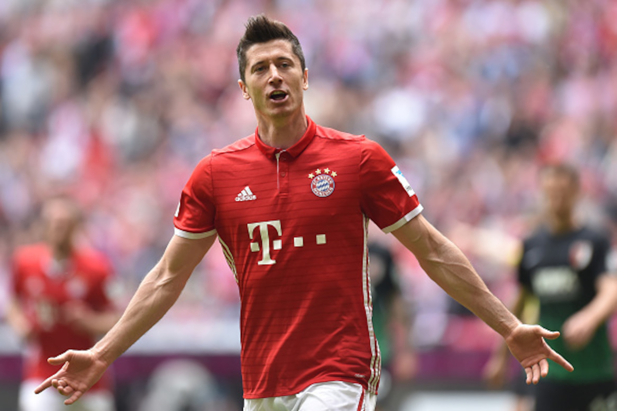 Bayern Munich's Polish striker Robert Lewandowski celebrates after scoring the 1-0 during the German first division Bundesliga football match between FC Schalke 04 and Borussia Dortmund in Gelsenkirchen, western Germany, on April 1, 2017. / AFP PHOTO / Ch