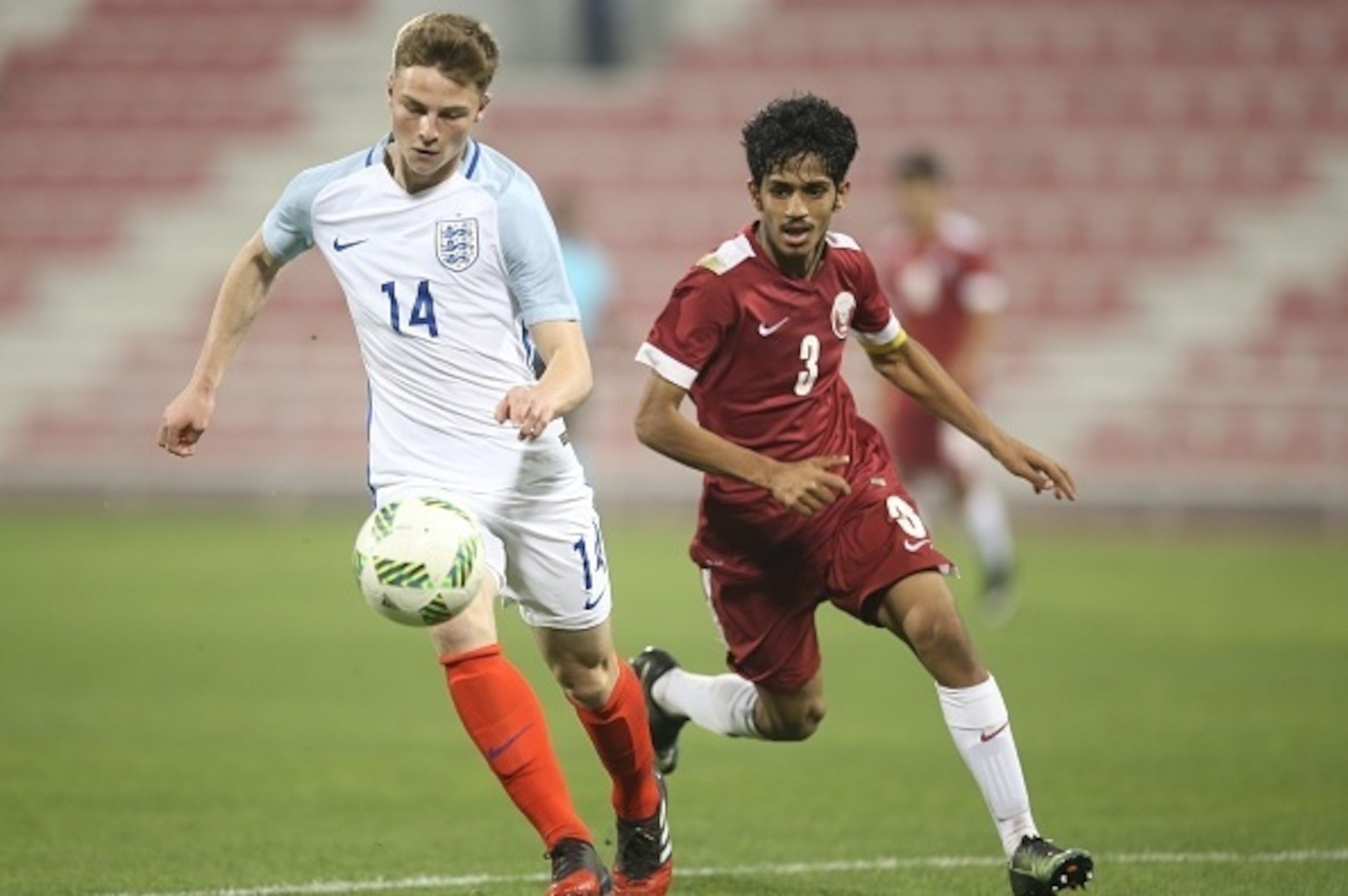 DOHA, QATAR - MARCH 27 : George Tanner of England in action against Ahmed Minhali of Qatar during the U18 International friendly match between Qatar and England at the Grand Hamad Stadium on March 27, 2017 in Doha, Qatar. (Photo by AK BijuRaj/Getty Images