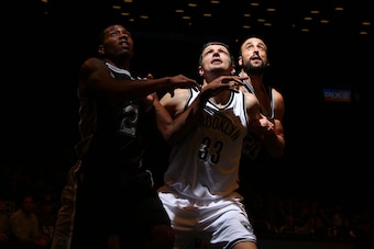Brooklyn's Mirza Teletovic (center) boxes out against Leonard and Manu Ginobili on December 3, 2014.