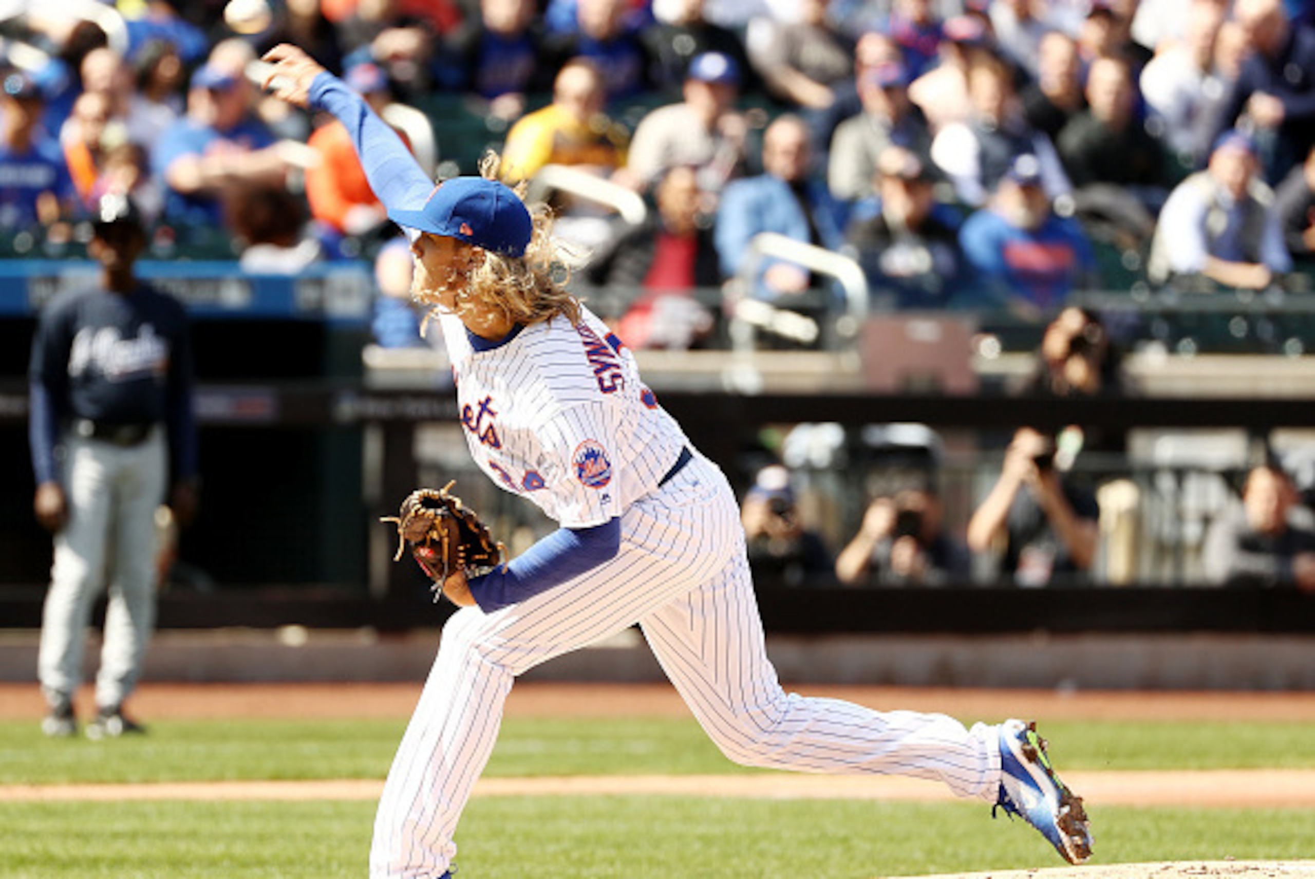 NEW YORK, NY - APRIL 03: Noah Syndergaard #34 of the New York Mets delivers a pitch in the first inning against the Atlanta Braves during Opening Day on April 3, 2017 at Citi Field in the Flushing neighborhood of the Queens borough of New York City. (Ph NEW YORK, NY - APRIL 03: Noah Syndergaard #34 of the New York Mets delivers a pitch in the first inning against the Atlanta Braves during Opening Day on April 3, 2017 at Citi Field in the Flushing neighborhood of the Queens borough of New York City. (Ph