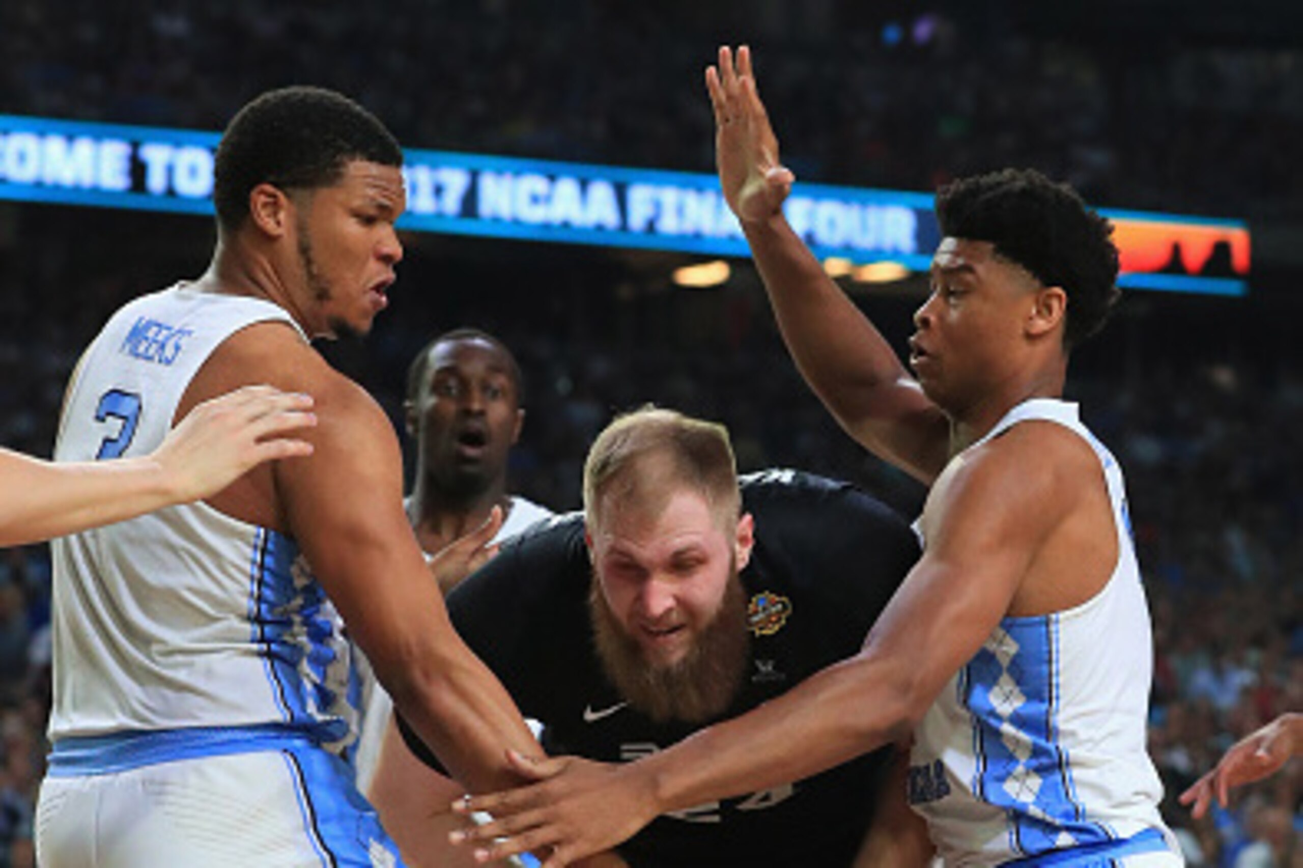 GLENDALE, AZ - APRIL 03: Przemek Karnowski #24 of the Gonzaga Bulldogs handles the ball against Kennedy Meeks #3 and Isaiah Hicks #4 of the North Carolina Tar Heels in the second half during the 2017 NCAA Men's Final Four National Championship game at Uni