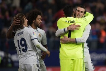 Real Madrid's Welsh forward Gareth Bale (R) celebrates their victory with Real Madrid's Costa Rican goalkeeper Keylor Navas (2ndR) past Real Madrid's Croatian midfielder Luka Modric (L) and Real Madrid's Brazilian defender Marcelo at the end of the Spanis