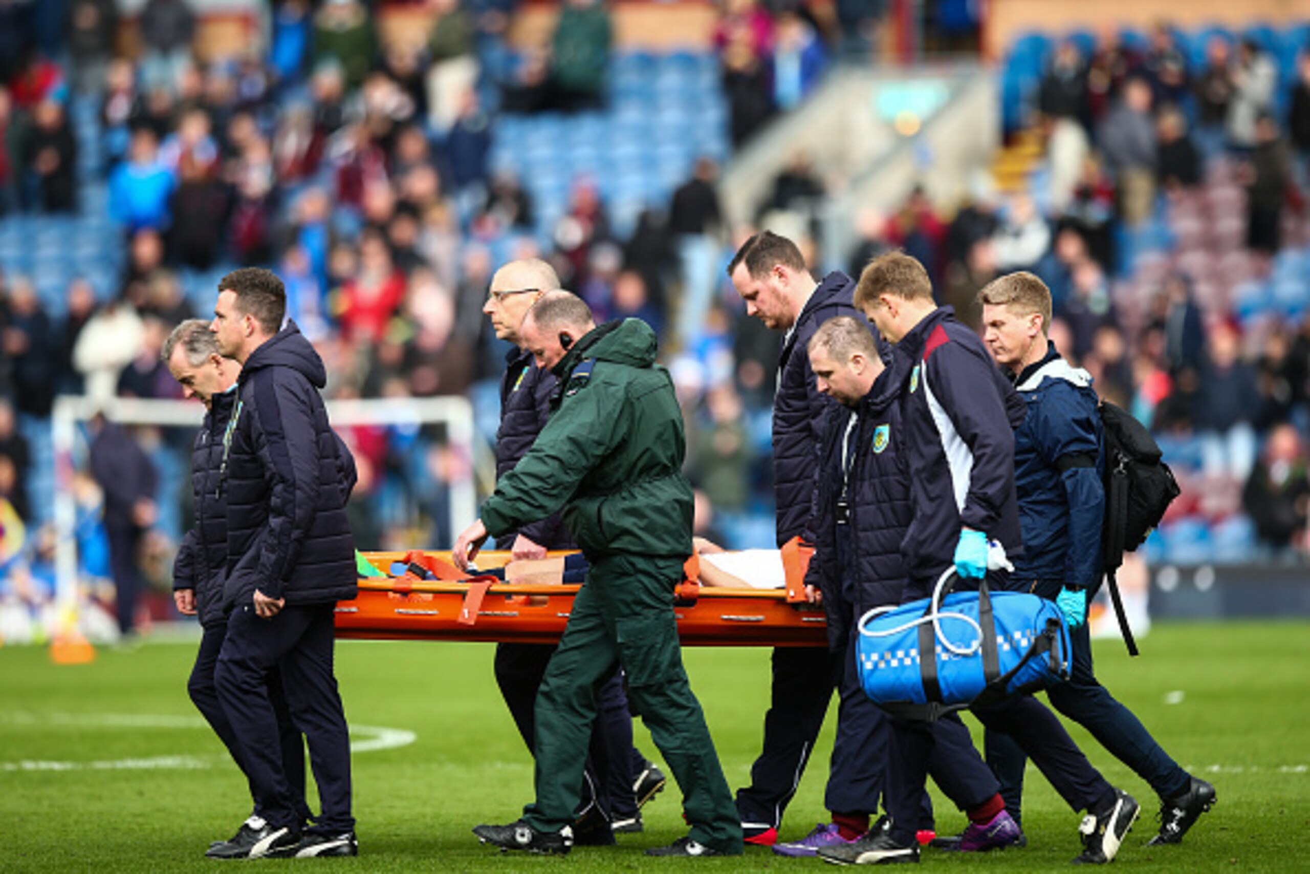 BURNLEY, ENGLAND - APRIL 01: Harry Winks of Tottenham Hotspur gets carried off injured at half time during the Premier League match between Burnley and Tottenham Hotspur at Turf Moor on April 1, 2017 in Burnley, England. (Photo by Robbie Jay Barratt - AMA