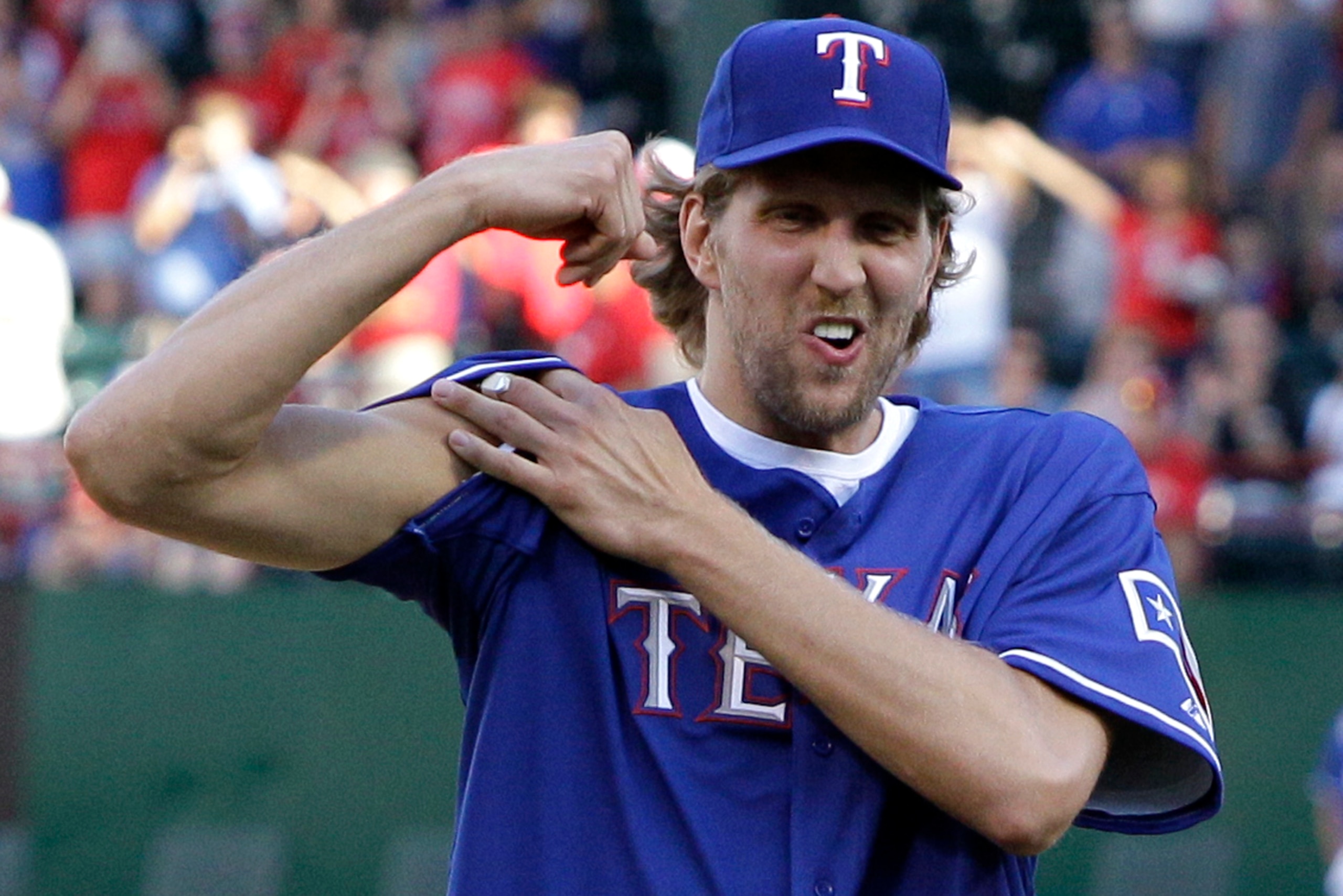 Dirk flexes his bicep after throwing out the honorary first pitch before a game between the New York Mets and Texas Rangers on June 24, 2011. Dirk flexes his bicep after throwing out the honorary first pitch before a game between the New York Mets and Texas Rangers on June 24, 2011.
