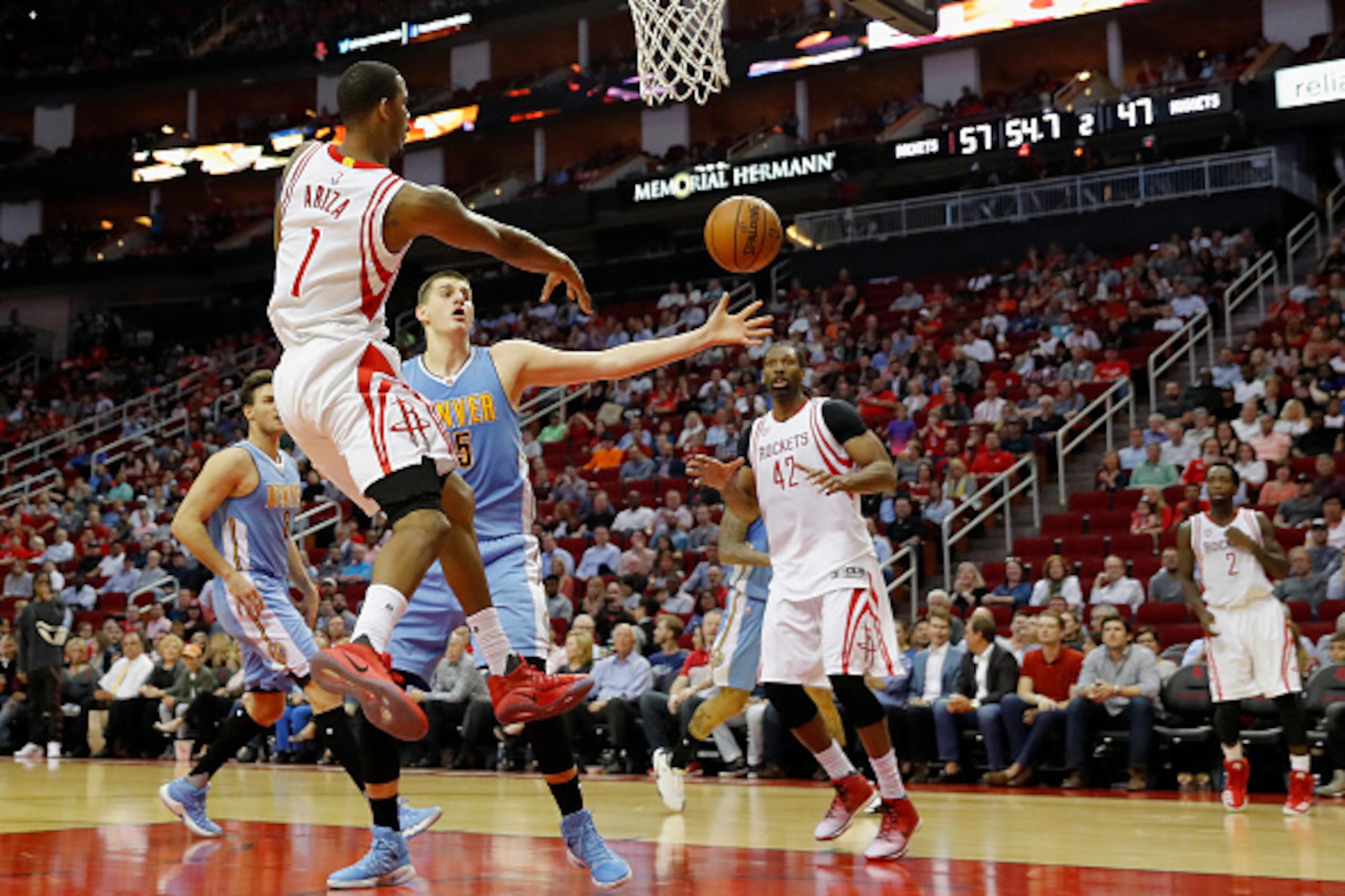 HOUSTON, TX - APRIL 05:  Trevor Ariza #1 of the Houston Rockets passes the ball to Patrick Beverley #2 on the perimeter defended by Nikola Jokic #15 of the Denver Nuggets in the first half at Toyota Center on April 5, 2017 in Houston, Texas.  NOTE TO USER