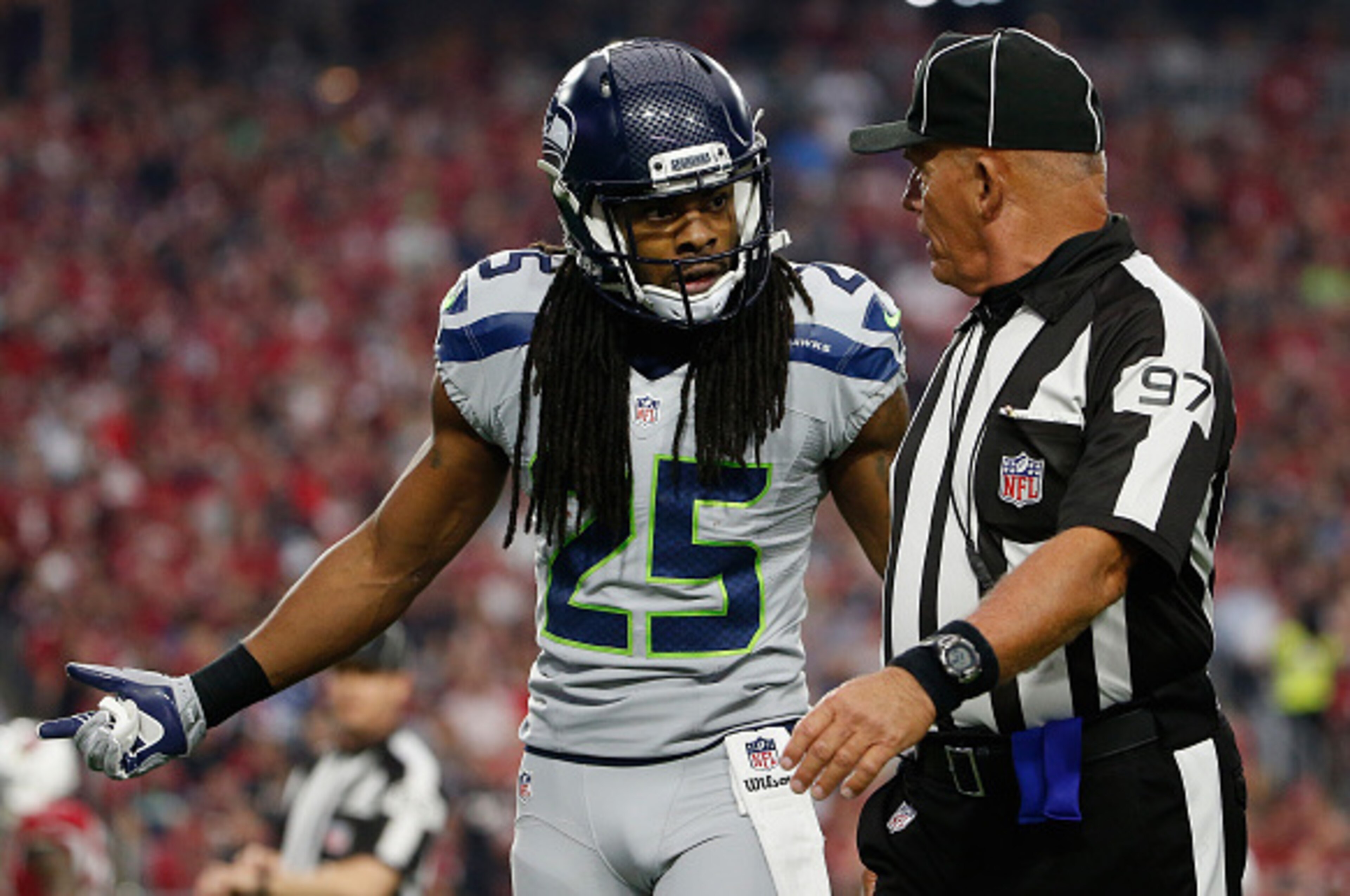 GLENDALE, AZ - JANUARY 03: Cornerback Richard Sherman #25 of the Seattle Seahawks argues with side judge Tom Hill #97 in the first quarter of the NFL game against the Arizona Cardinals at the University of Phoenix Stadium on January 3, 2016 in Glendale, A