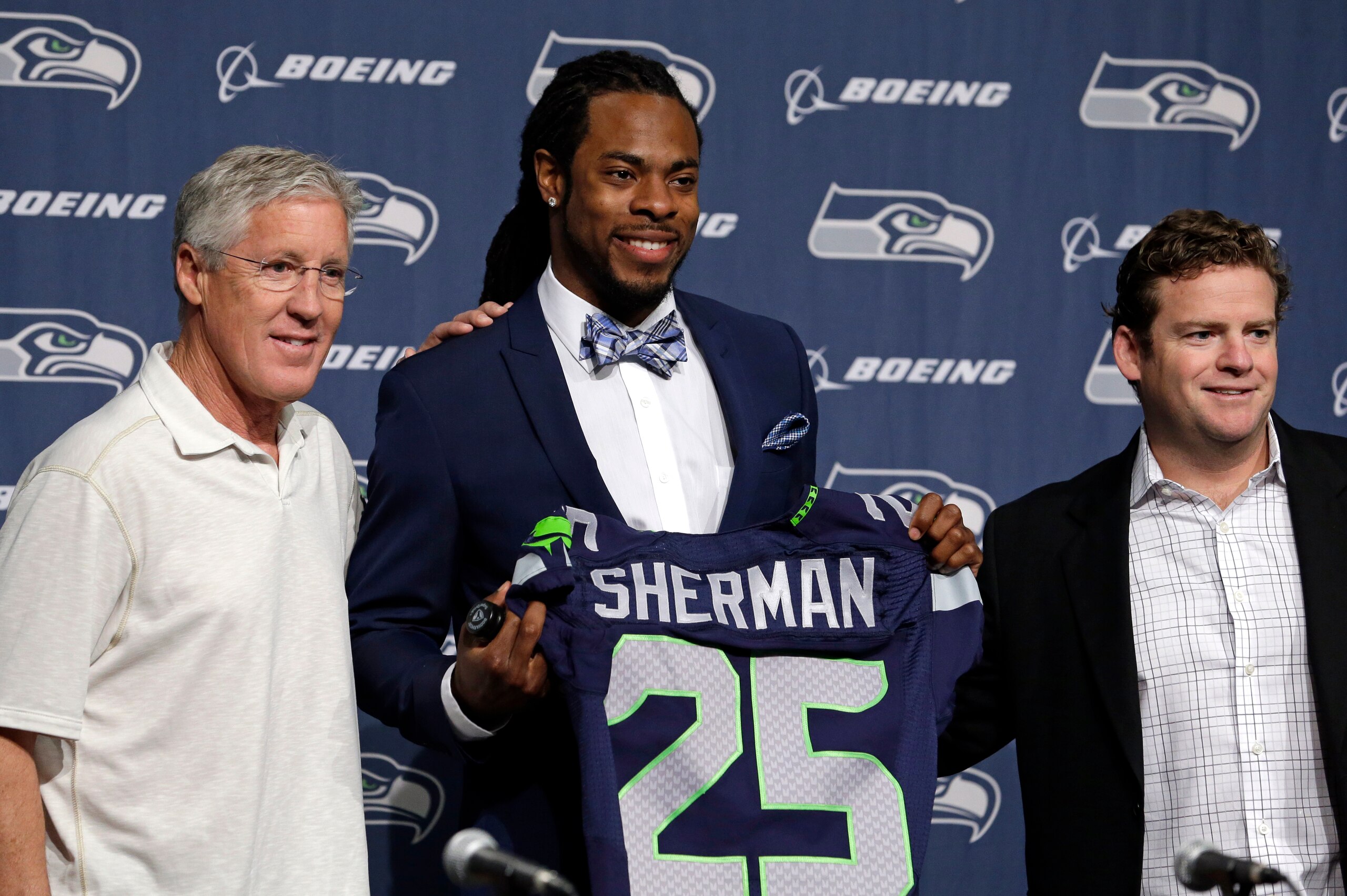 Pete Carroll, Richard Sherman and GM John Schneider in  happier times in 2014.