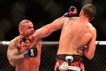 May 30, 2015; Goiania, GO, Brazil; Carlos Condit (red gloves) fights Thiago Alves (blue gloves) during UFC Fight Night at Goiania Arena. Mandatory Credit: Jason Silva-USA TODAY Sports