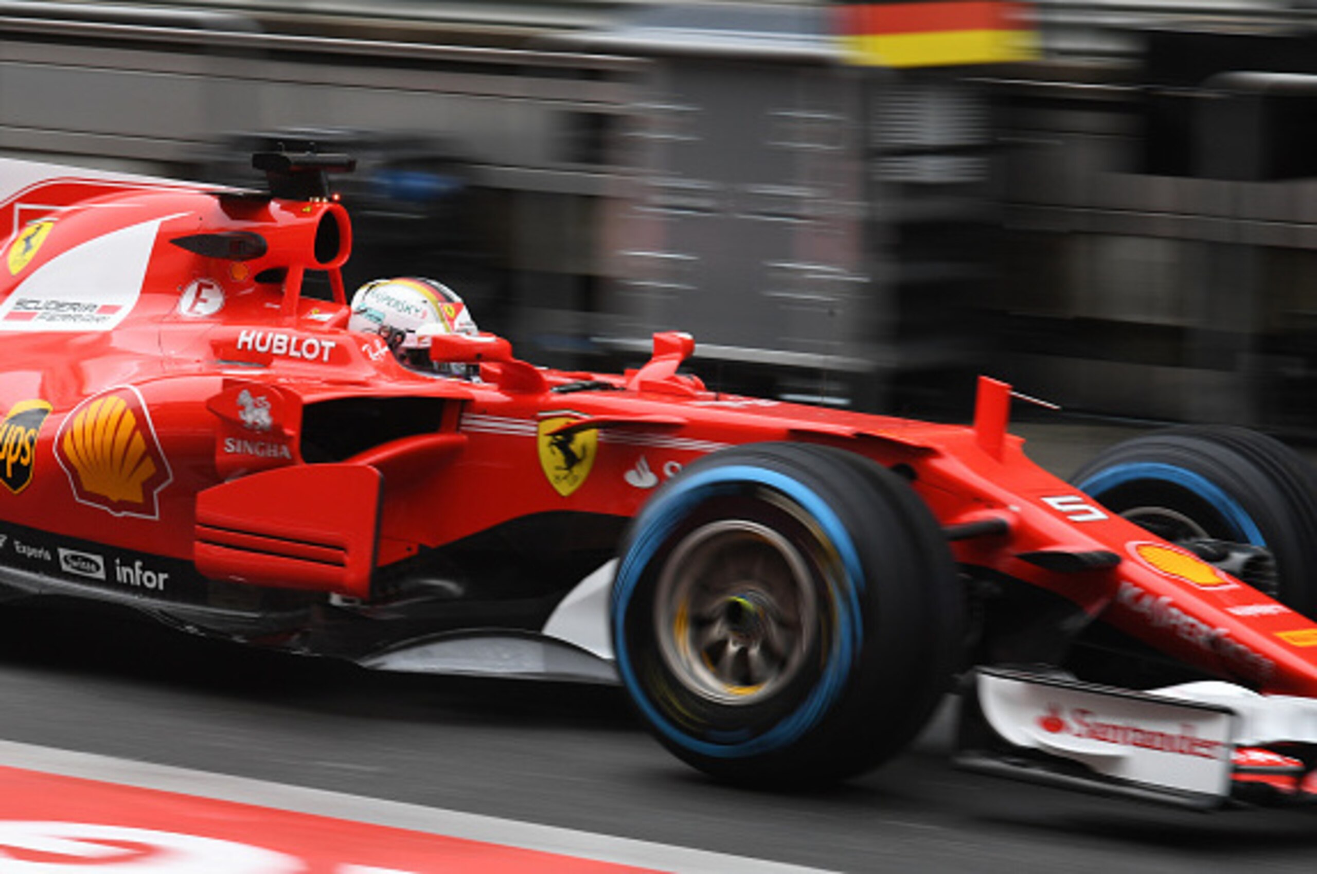 Ferrari's German driver Sebastian Vettel drives through the pit lane during the practice session ahead of the Formula One Chinese Grand Prix in Shanghai on April 7, 2017. / AFP PHOTO / GREG BAKER        (Photo credit should read GREG BAKER/AFP/Getty Image