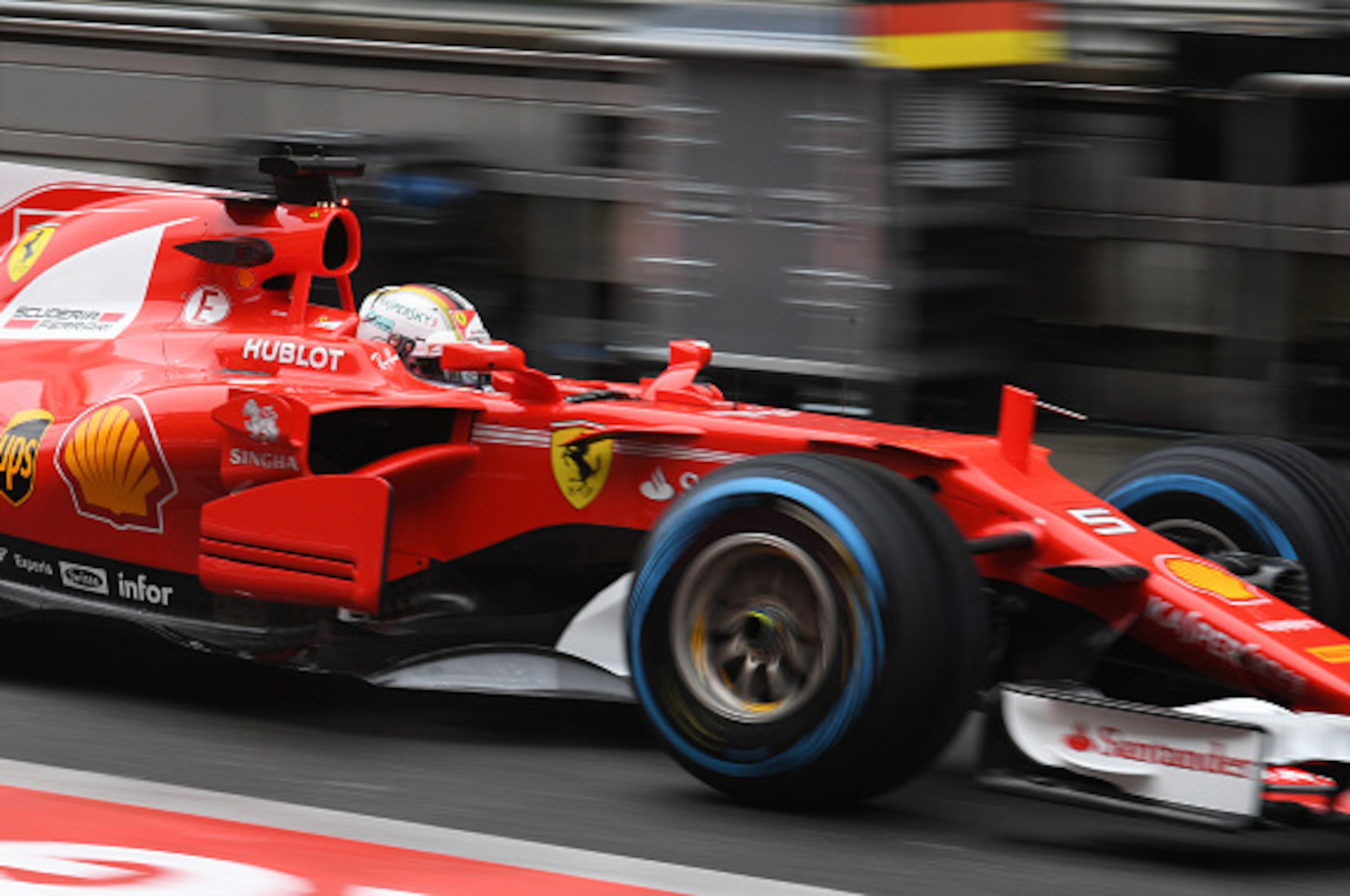 Ferrari's German driver Sebastian Vettel drives through the pit lane during the practice session ahead of the Formula One Chinese Grand Prix in Shanghai on April 7, 2017. / AFP PHOTO / GREG BAKER        (Photo credit should read GREG BAKER/AFP/Getty Image