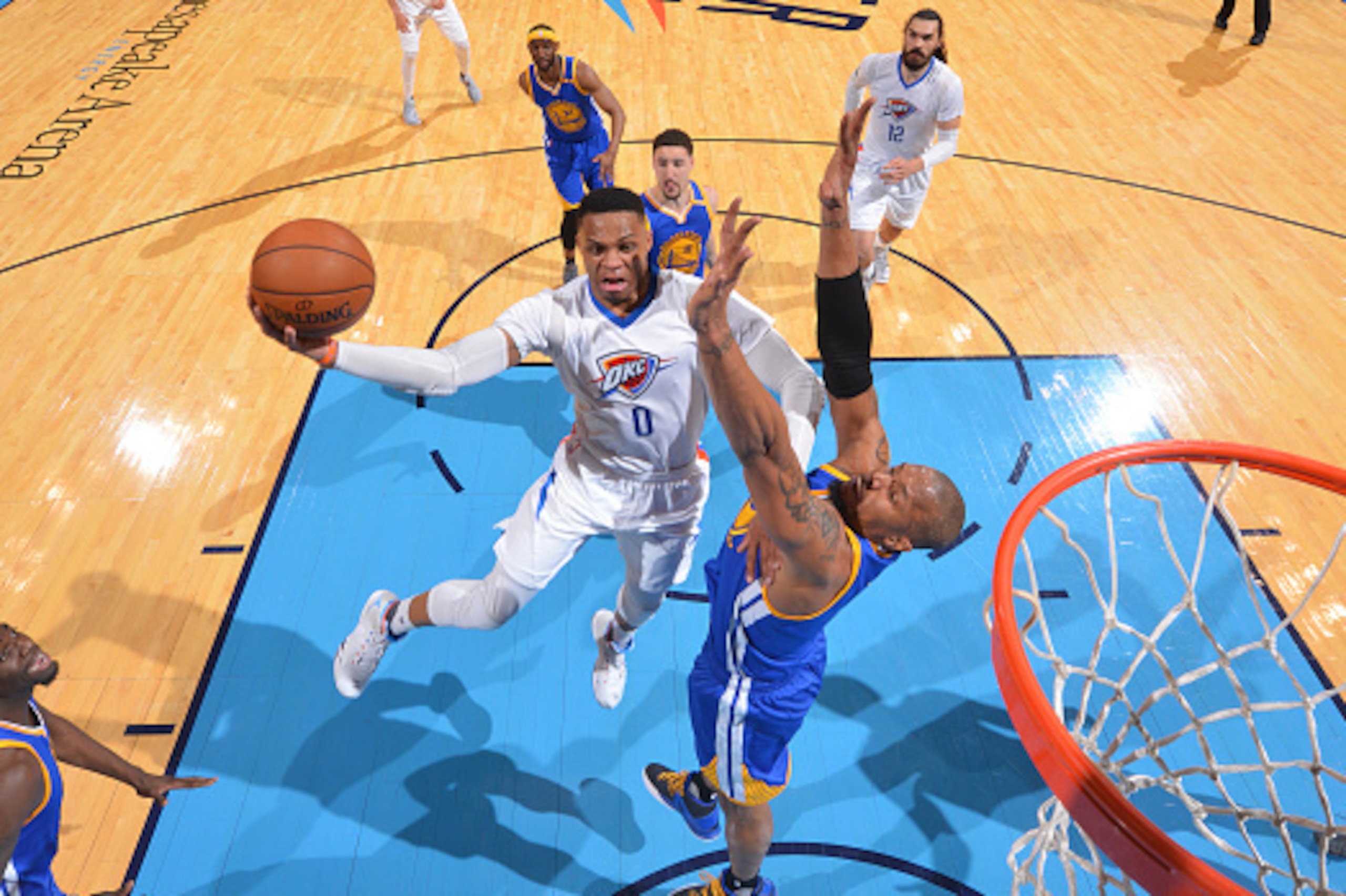OKLAHOMA CITY, OK - MARCH 20: Russell Westbrook #0 of the Oklahoma City Thunder goes up for the layup against the Golden State Warriors during the game on March 20, 2017 at Chesapeake Energy Arena in Oklahoma City, Oklahoma. NOTE TO USER: User expressly a