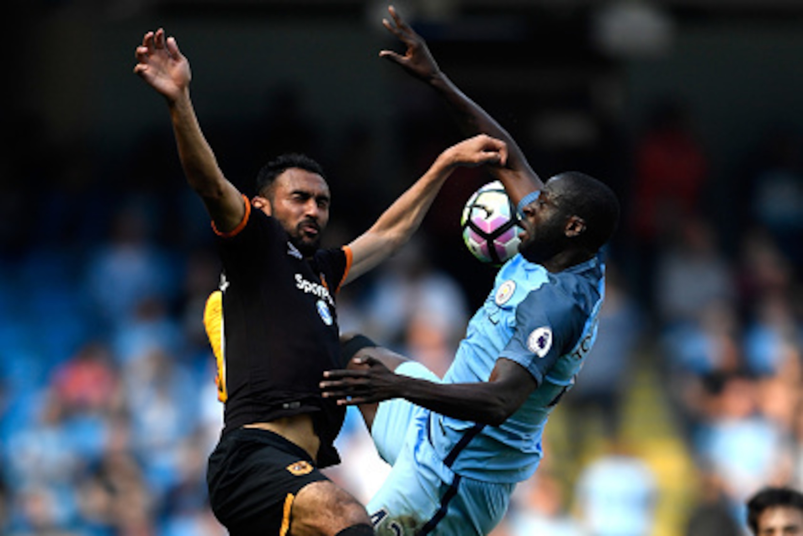 MANCHESTER, ENGLAND - APRIL 08: Ahmed Elmohamady of Hull City and Yaya Toure of Manchester City battle for possession during the Premier League match between Manchester City and Hull City at Etihad Stadium on April 8, 2017 in Manchester, England.  (Photo 