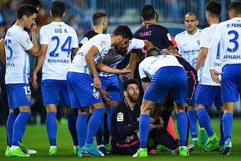 MALAGA, SPAIN - APRIL 08:  Lionel Messi of FC Barcelona argues with Malaga players after being brought down during the La Liga match between Malaga CF and FC Barcelona at La Rosaleda stadium on April 8, 2017 in Malaga, Spain.  (Photo by David Ramos/Getty 