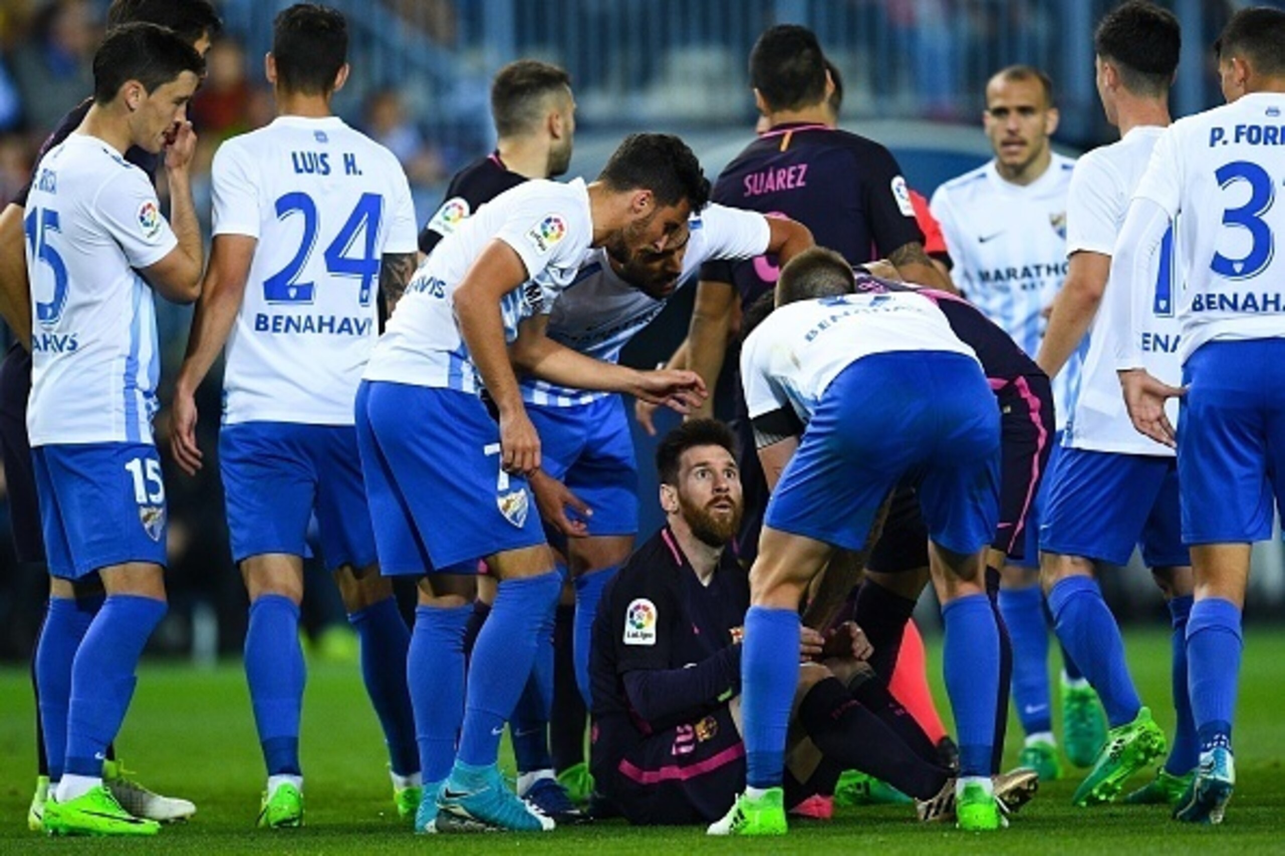MALAGA, SPAIN - APRIL 08:  Lionel Messi of FC Barcelona argues with Malaga players after being brought down during the La Liga match between Malaga CF and FC Barcelona at La Rosaleda stadium on April 8, 2017 in Malaga, Spain.  (Photo by David Ramos/Getty 