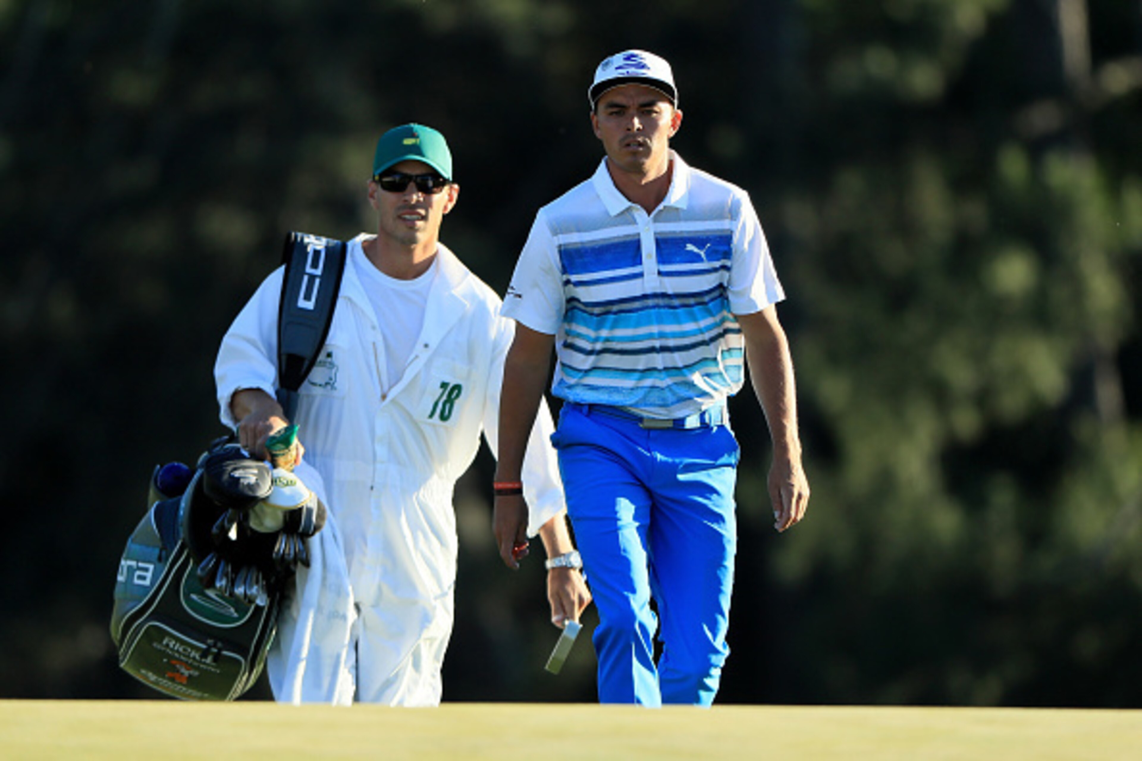 AUGUSTA, GA - APRIL 08:  Rickie Fowler of the United States and his caddie Joseph Skovron walk to the on the 18th hole green during the third round of the 2017 Masters Tournament at Augusta National Golf Club on April 8, 2017 in Augusta, Georgia.  (Photo 