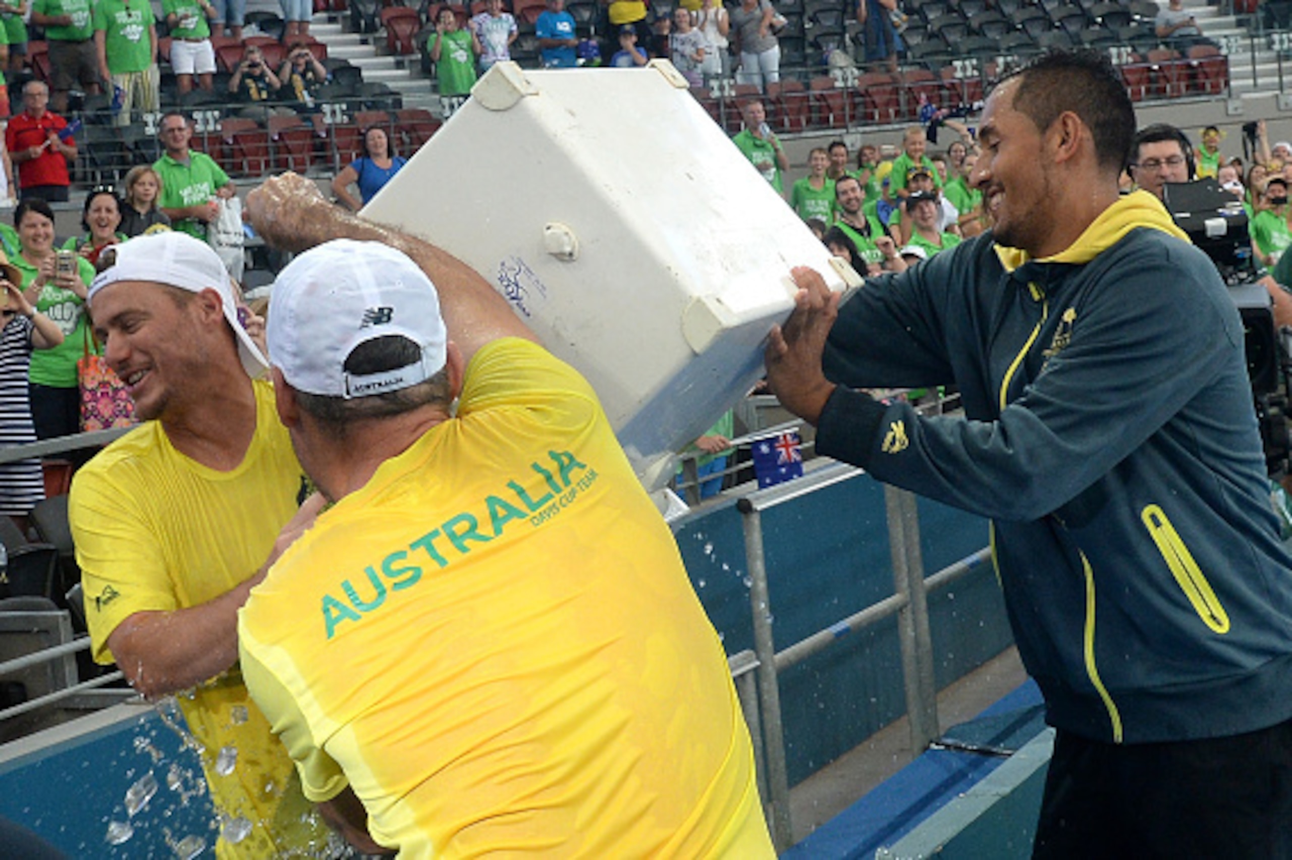 BRISBANE, AUSTRALIA - APRIL 09:  Nick Kyrgios of Australia pours a bucket of ice over Team Captain Lleyton Hewitt after their victory in the Davis Cup World Group Quarterfinals between Australia and the USA at Pat Rafter Arena on April 9, 2017 in Brisbane