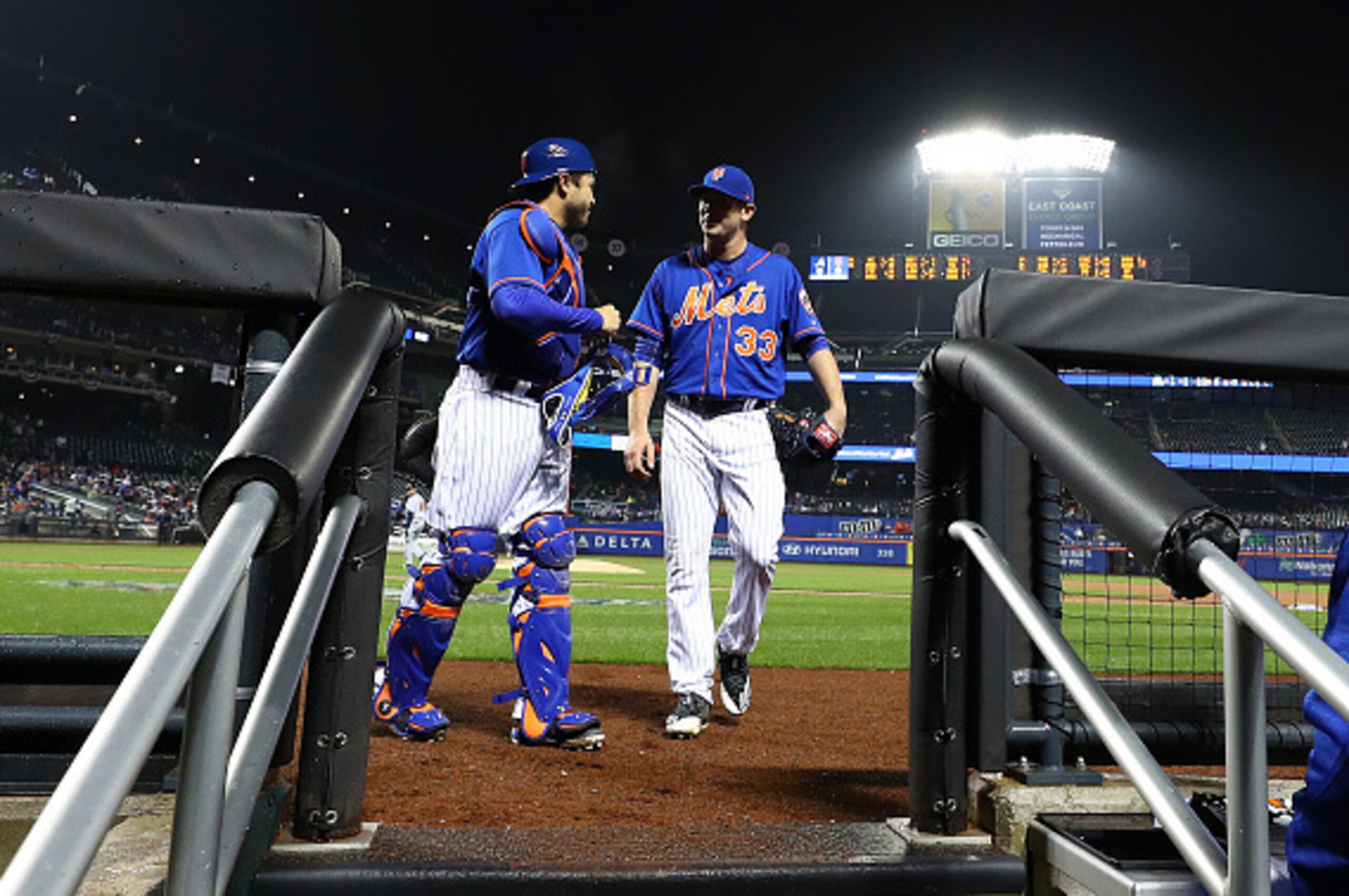 NEW YORK, NY - APRIL 06:  Travis d'Arnaud #18 and Matt Harvey #33 of the New York Mets walk into the dugout after the fourth inning against the Atlanta Braves during their game at Citi Field on April 6, 2017 in New York City.  (Photo by Al Bello/Getty Ima