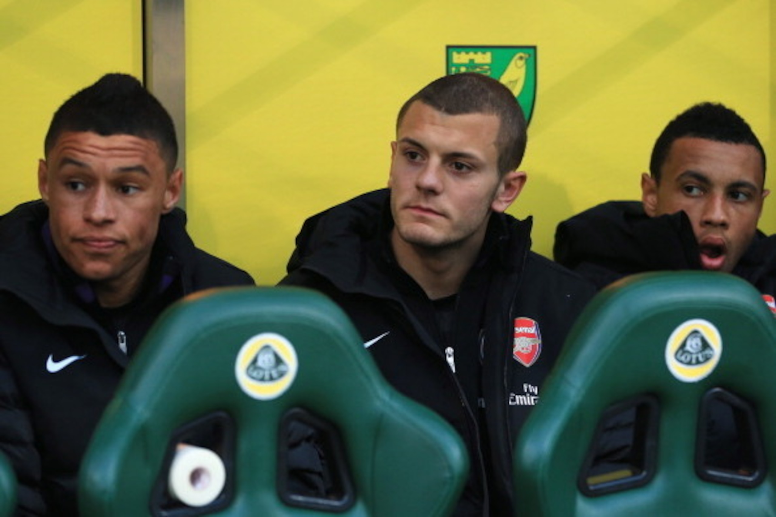 NORWICH, ENGLAND - OCTOBER 20:  (L-R) Alex Oxlade-Chamberlain, Jack Wilshere and Francis Coquelin of Arsenal look on from the bench prior to the Barclays Premier League match between  Norwich City and Arsenal at Carrow Road on October 20, 2012 in Norwich,