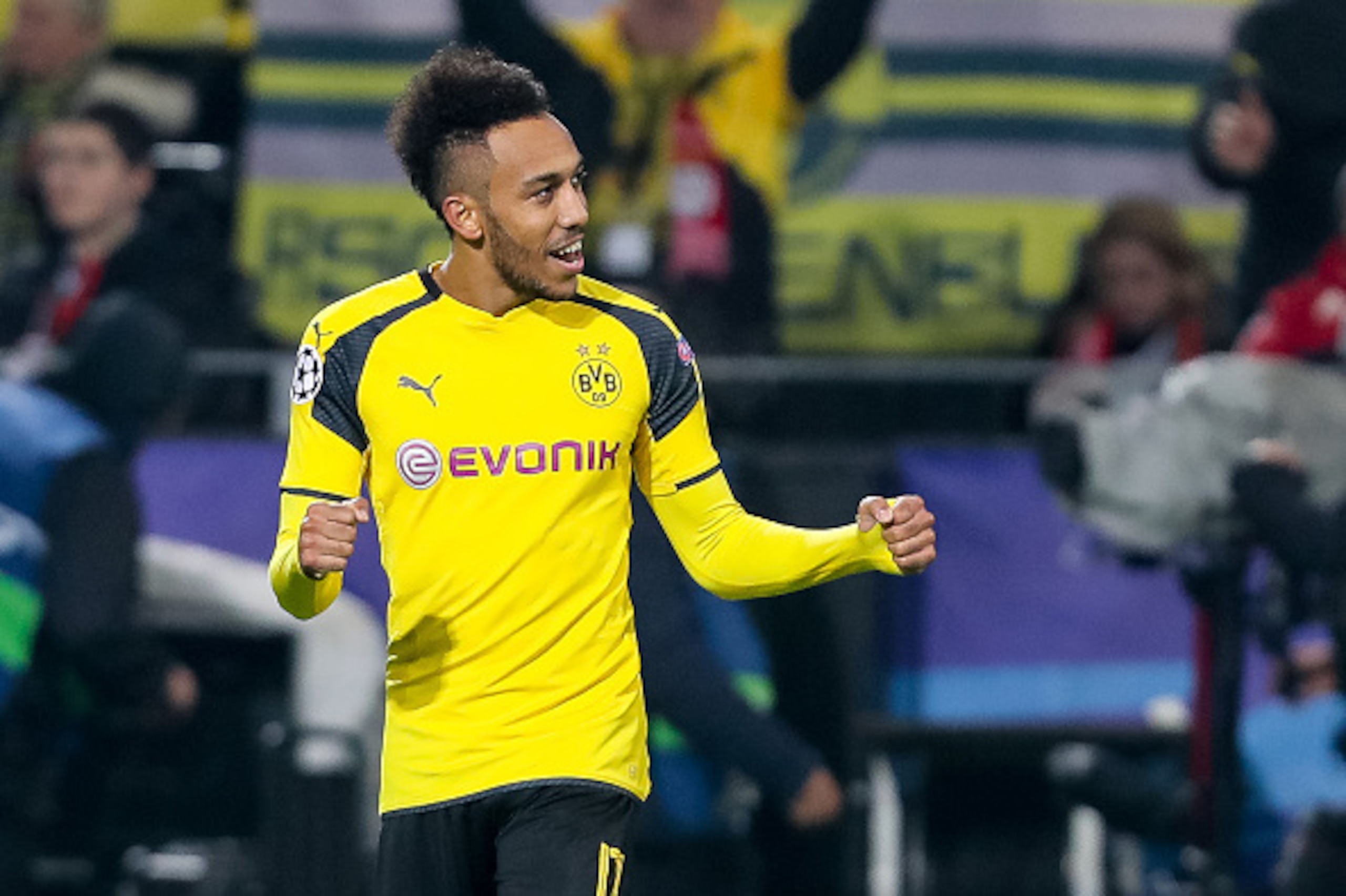 DORTMUND, GERMANY - MARCH 08: Pierre-Emerick Aubameyang of Borussia Dortmund celebrates scoring his team's fourth goal to make the score 4-0 and complete his hat-trick during the UEFA Champions League Round of 16: Second Leg match between Borussia Dortmun DORTMUND, GERMANY - MARCH 08: Pierre-Emerick Aubameyang of Borussia Dortmund celebrates scoring his team's fourth goal to make the score 4-0 and complete his hat-trick during the UEFA Champions League Round of 16: Second Leg match between Borussia Dortmun