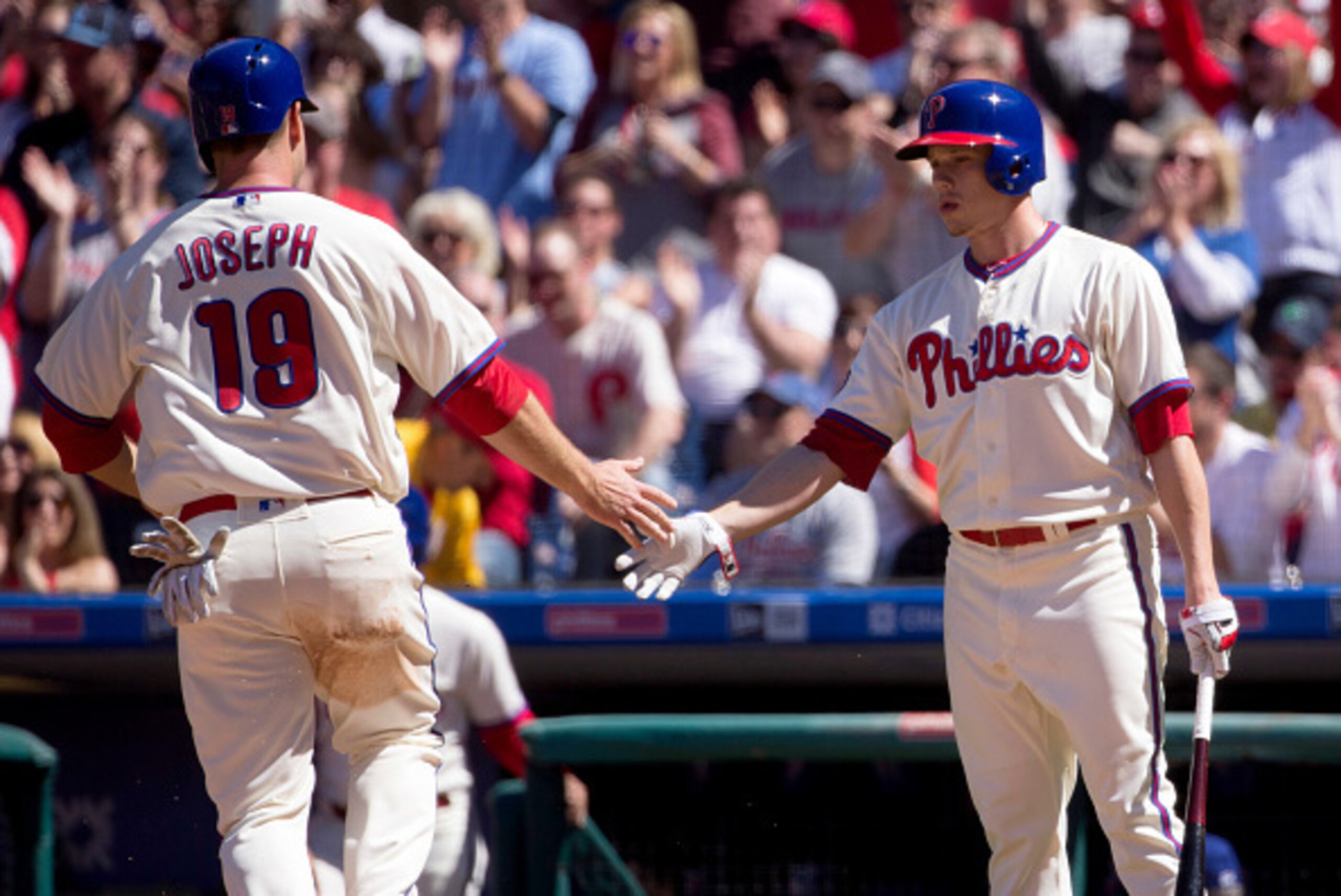 PHILADELPHIA, PA - APRIL 09: Tommy Joseph #19 of the Philadelphia Phillies scores a run in the bottom of the second inning and is congratulated by Jeremy Hellickson #58 of the Philadelphia Phillies in the bottom of the second inning against the Washington