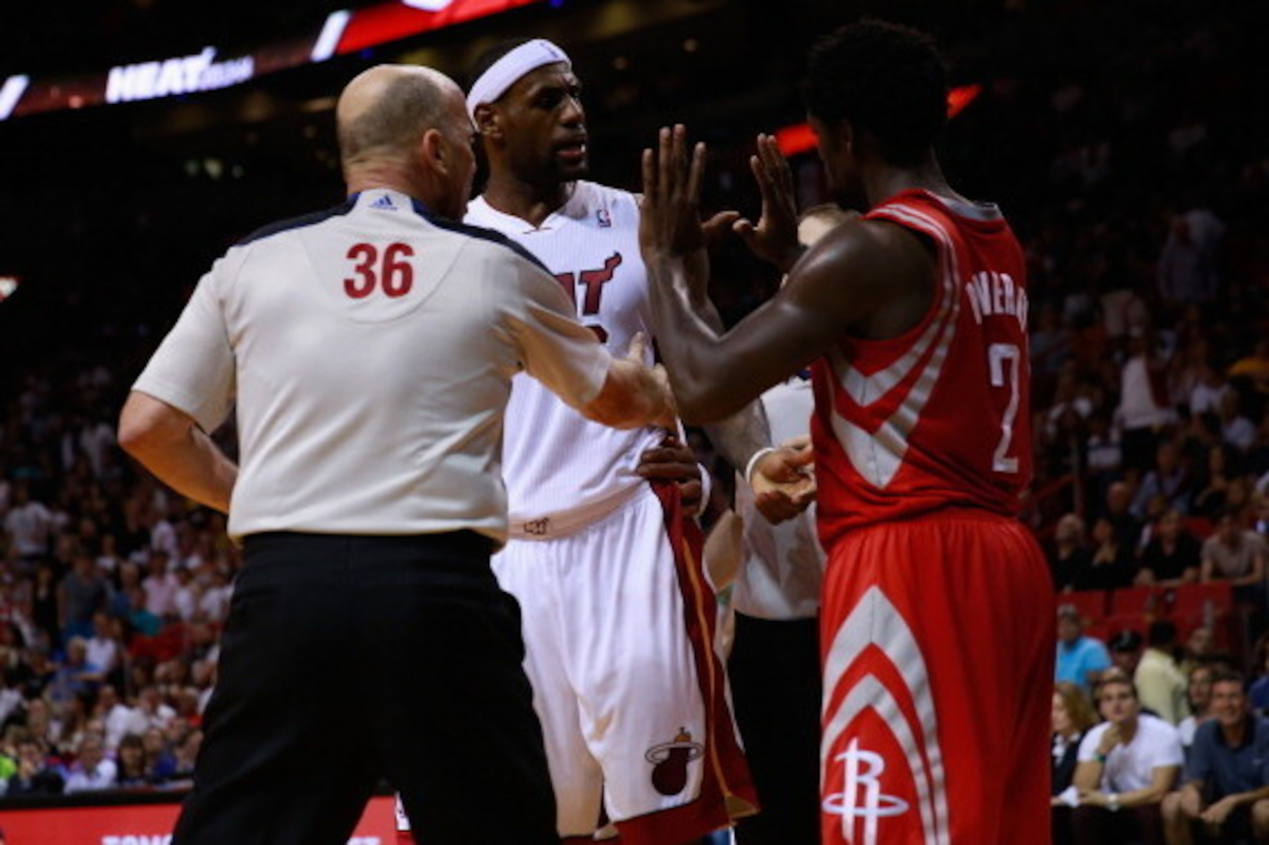 MIAMI, FL - MARCH 16: Referee David Jones separates (L) LeBron James #6 of the Miami Heat and (R) Patrick Beverley #2 of the Houston Rockets in the fourth quarter at American Airlines Arena on March 16, 2014 in Miami, Florida. NOTE TO USER: User expressly