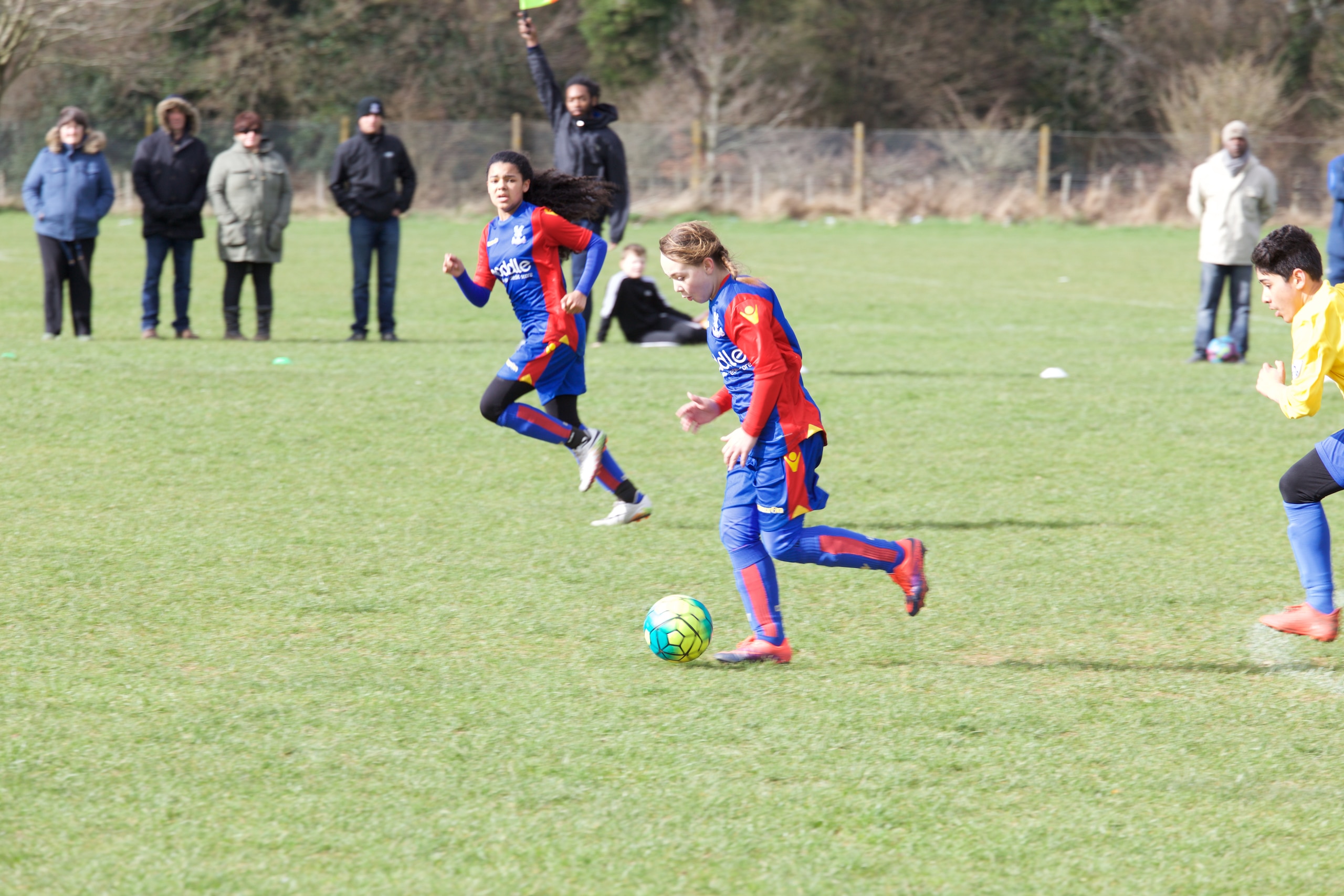 Jessica Ellum runs through on the ball, with Angel Johnson in the background