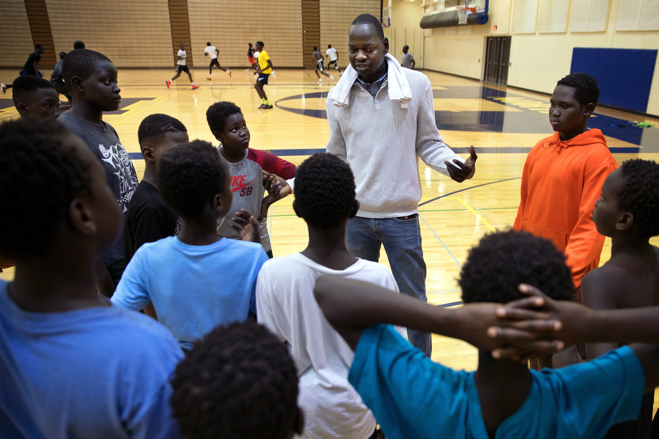 Omaha Talons Academy Director Koang Doluony talks with a group of fifth-grade basketball players during a practice at Omaha North High Magnet School.