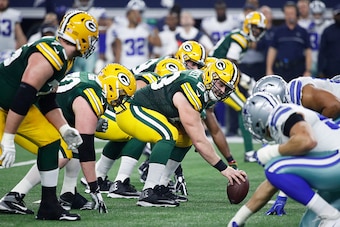 ARLINGTON, TX - JANUARY 15: Corey Linsley #63 of the Green Bay Packers gets set to snap the ball during the NFC Divisional Playoff game against the Dallas Cowboys at AT&T Stadium on January 15, 2017 in Arlington, Texas. The Packers defeated the Cowboys 34