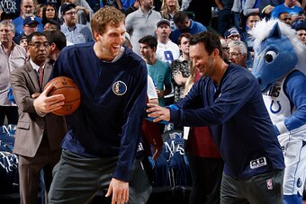 DALLAS, TX - APRIL 11:  Former Dallas Cowboys quarterback Tony Romo warms up with Dirk Nowitzki #41 of the Dallas Mavericks before the game against the Denver Nuggets on April 11, 2017 at the American Airlines Center in Dallas, Texas. NOTE TO USER: User e