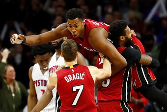 AUBURN HILLS, MI - MARCH 28: Hassan Whiteside #21 of the Miami Heat celebrates his buzzer beating game winning basket with James Johnson #16 and Goran Dragic #7 in front of Andre Drummond #0 of the Detroit Pistons at the Palace of Auburn Hills on March 28
