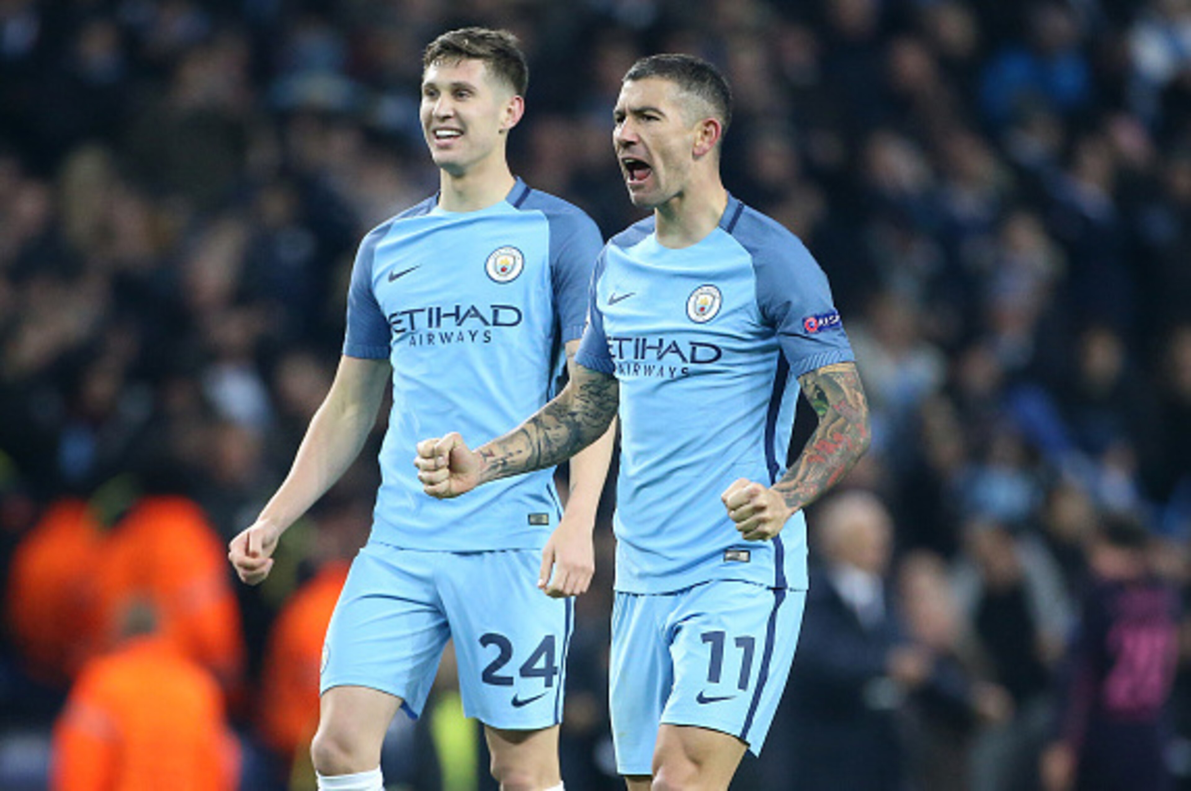 MANCHESTER, ENGLAND - NOVEMBER 1: Aleksandar Kolarov and John Stones of Manchester City (left) celebrate winning  following the UEFA Champions League match between Manchester City FC and FC Barcelona at Etihad Stadium on November 1, 2016 in Manchester, En