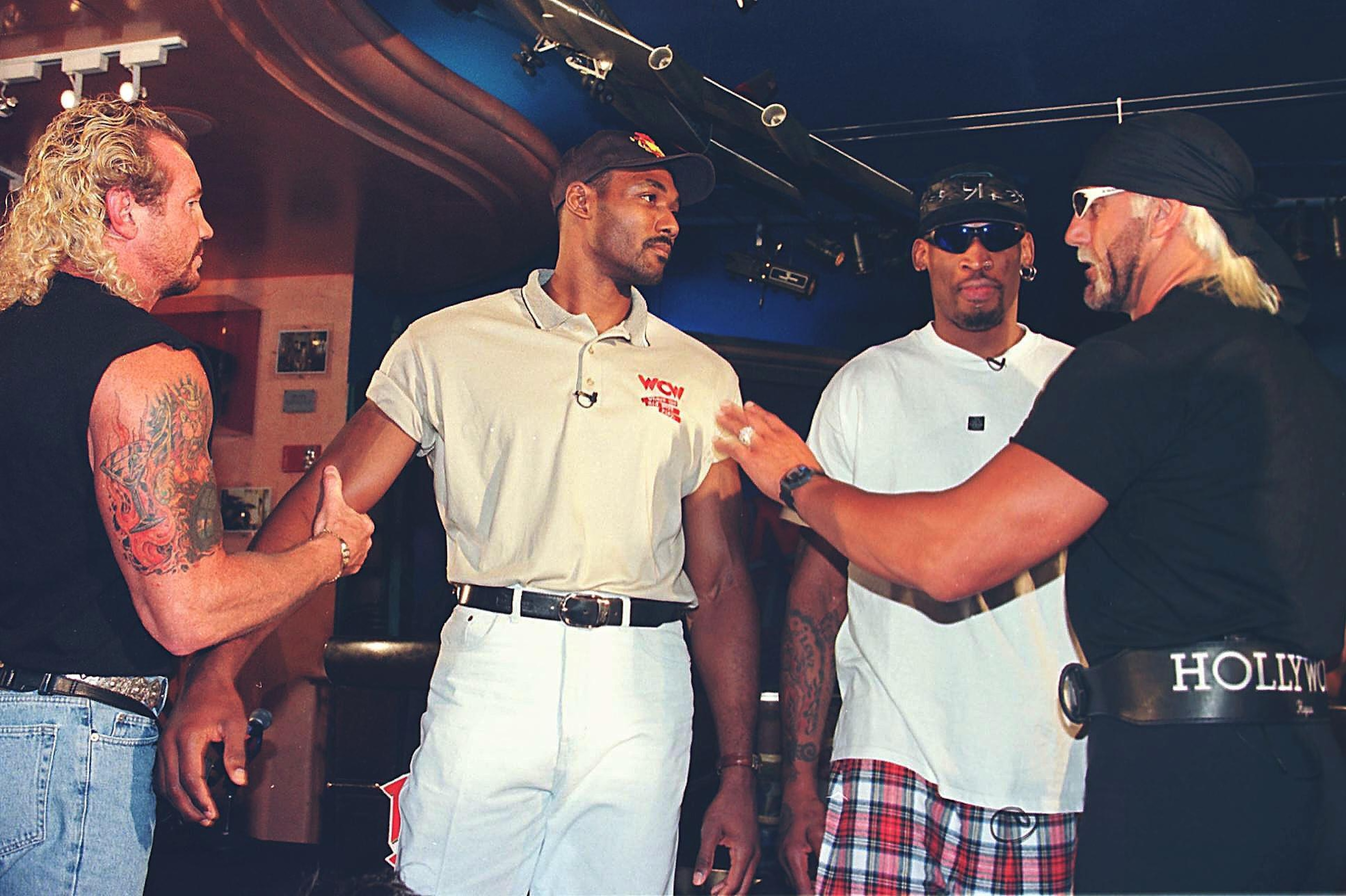 Karl Malone is restrained by Diamond Dallas Page as Hulk Hogan pushes him following a press conference to announce that Malone will meet Dennis Rodman (aka Rodzilla) at the "Bash At The Beach" in July 1998.