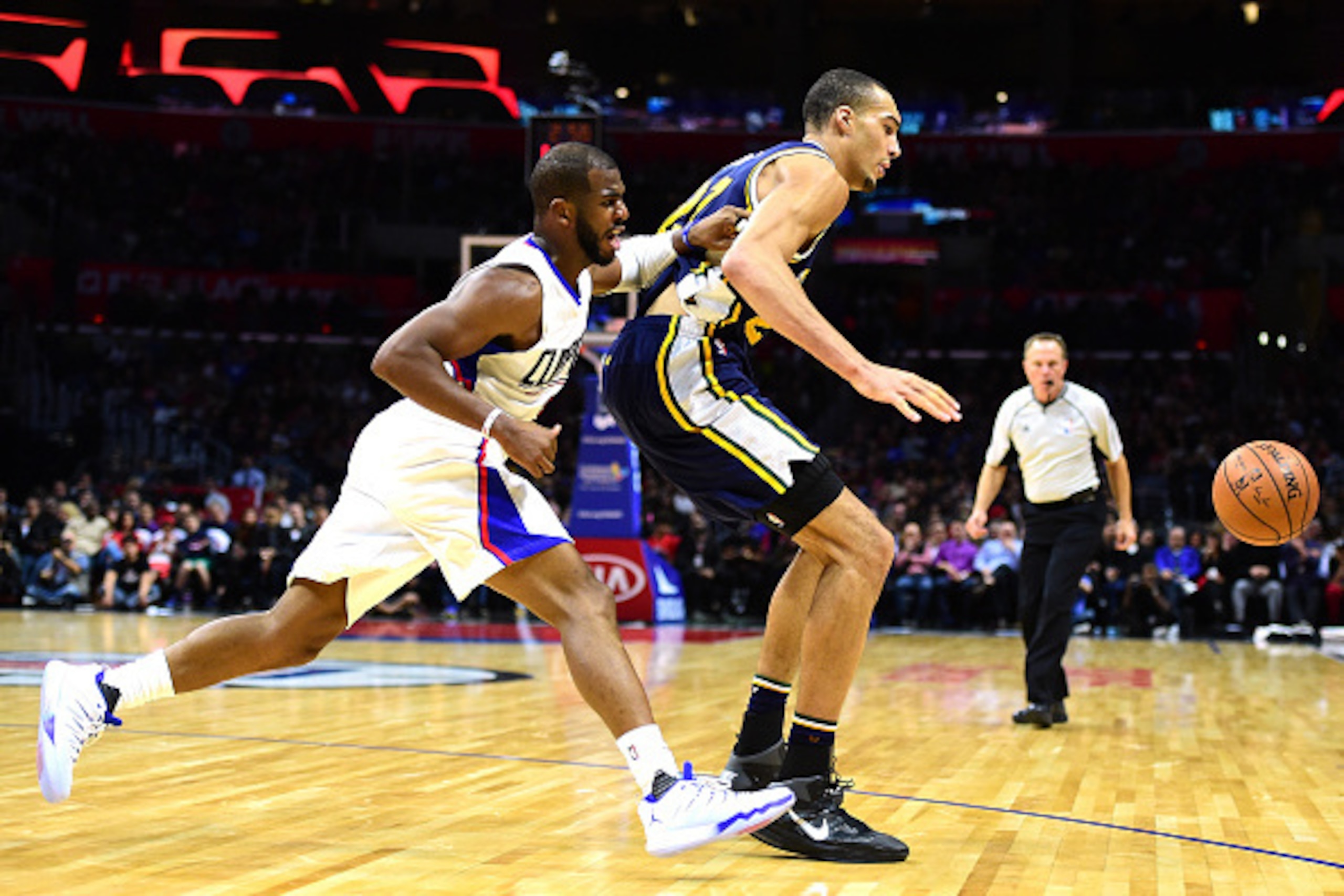 LOS ANGELES, CA - NOVEMBER 25:  Rudy Gobert #27 of the Utah Jazz and Chris Paul #3 of the Los Angeles Clippers go after a loose ball at Staples Center on November 25, 2015 in Los Angeles, California.  (Photo by Harry How/Getty Images)