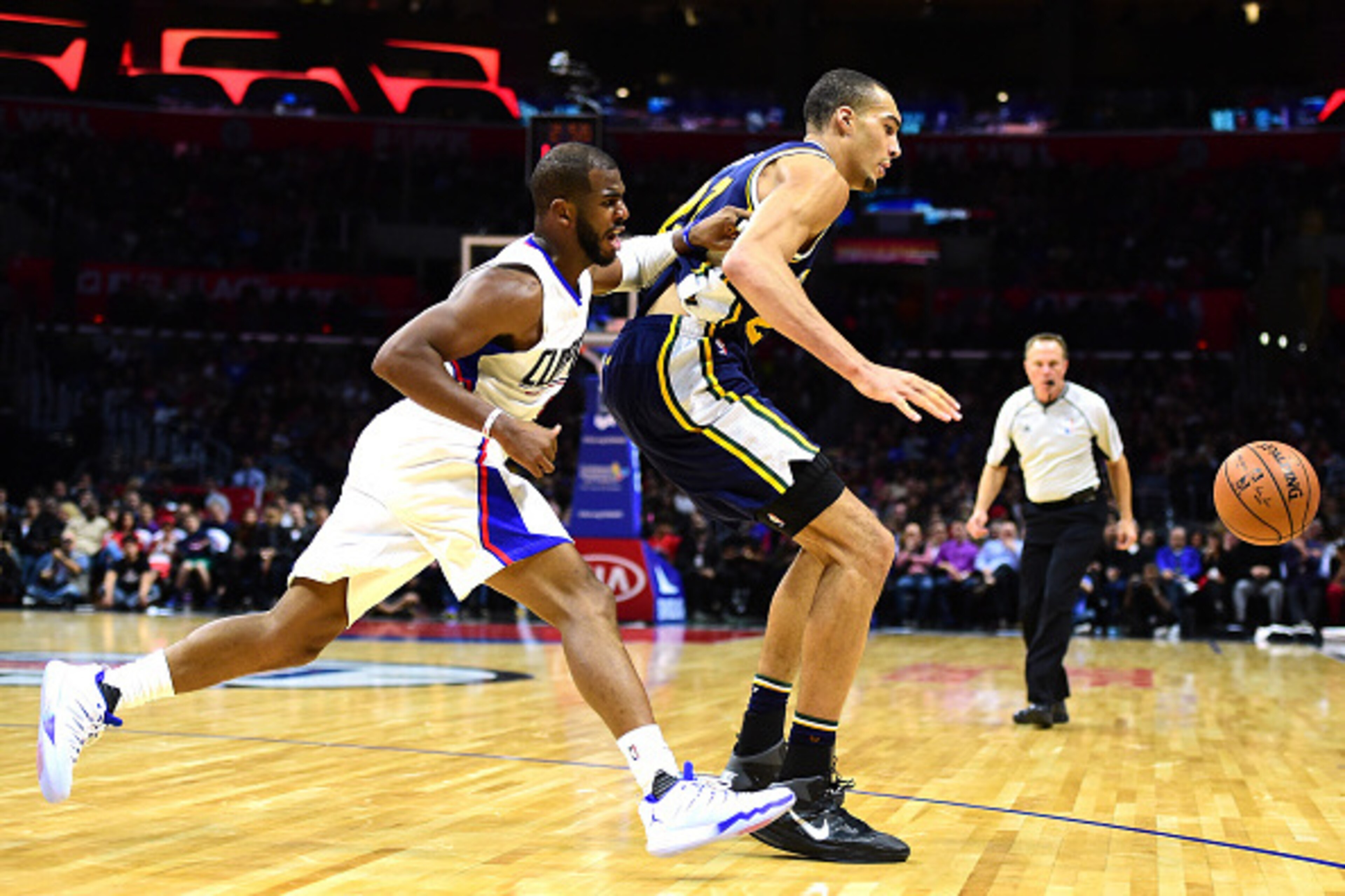 LOS ANGELES, CA - NOVEMBER 25:  Rudy Gobert #27 of the Utah Jazz and Chris Paul #3 of the Los Angeles Clippers go after a loose ball at Staples Center on November 25, 2015 in Los Angeles, California.  (Photo by Harry How/Getty Images)