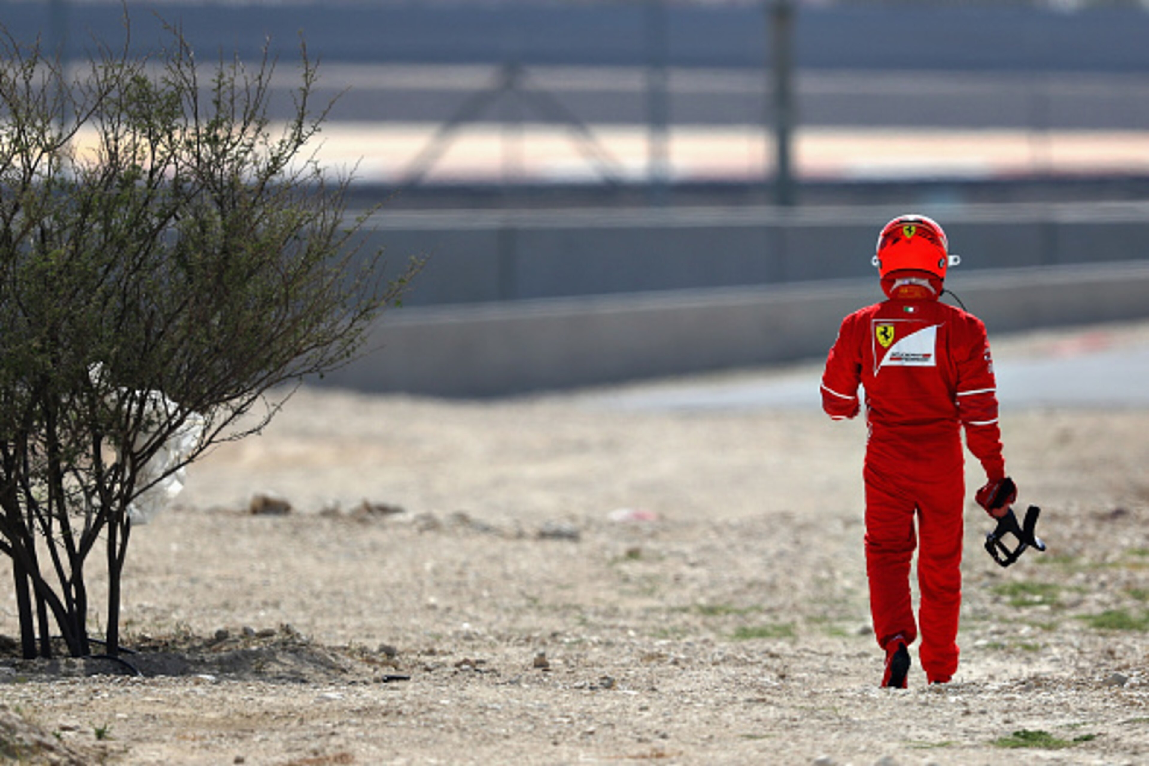 BAHRAIN, BAHRAIN - APRIL 14: Kimi Raikkonen of Finland and Ferrari walks away after breaking down on track during practice for the Bahrain Formula One Grand Prix at Bahrain International Circuit on April 14, 2017 in Bahrain, Bahrain.  (Photo by Clive Maso
