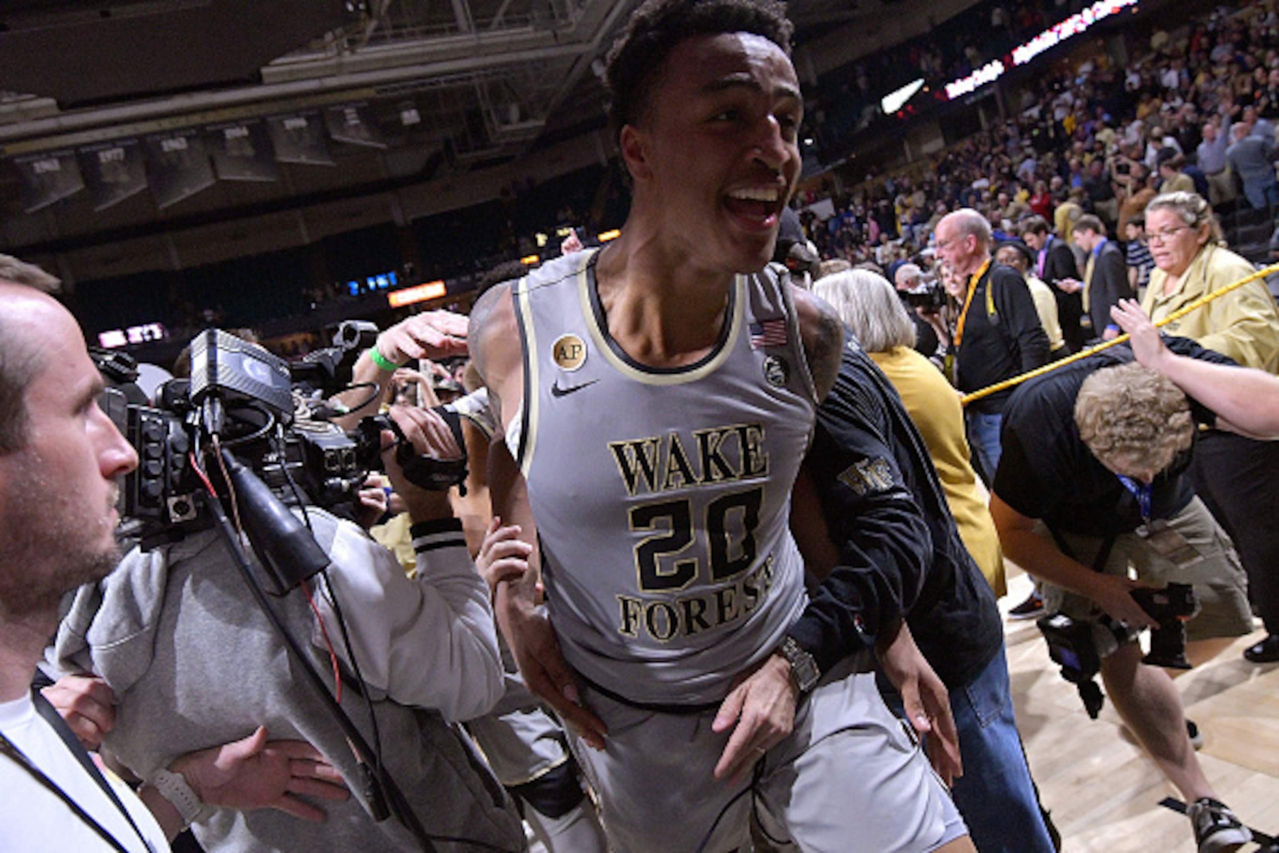 WINSTON-SALEM, NC - MARCH 01:  John Collins #20 of the Wake Forest Demon Deacons leaves the floor after a win against the Louisville Cardinals at the LJVM Coliseum Complex on March 1, 2017 in Winston-Salem, North Carolina. Wake Forest won 88-81.  (Photo b
