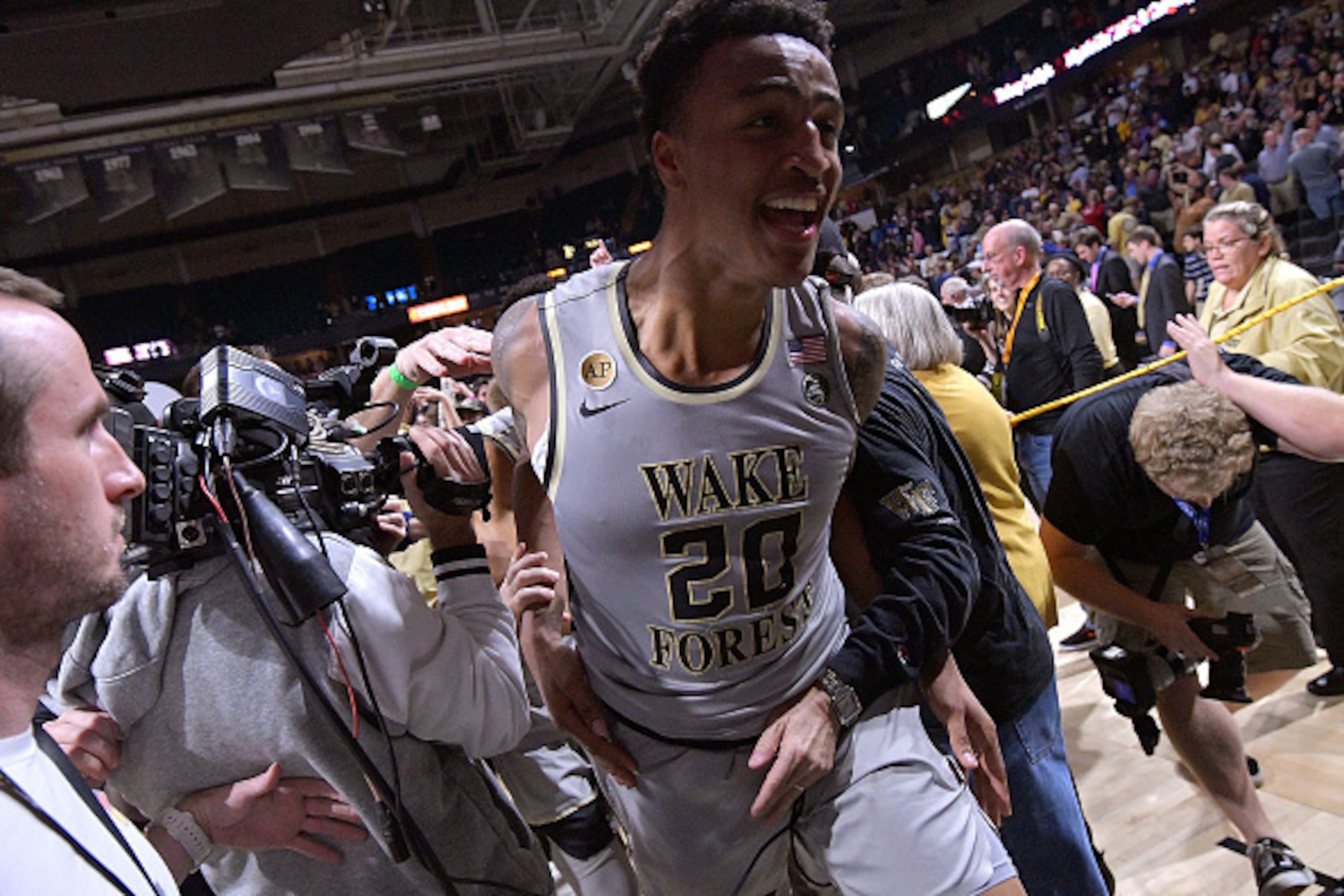 WINSTON-SALEM, NC - MARCH 01:  John Collins #20 of the Wake Forest Demon Deacons leaves the floor after a win against the Louisville Cardinals at the LJVM Coliseum Complex on March 1, 2017 in Winston-Salem, North Carolina. Wake Forest won 88-81.  (Photo b