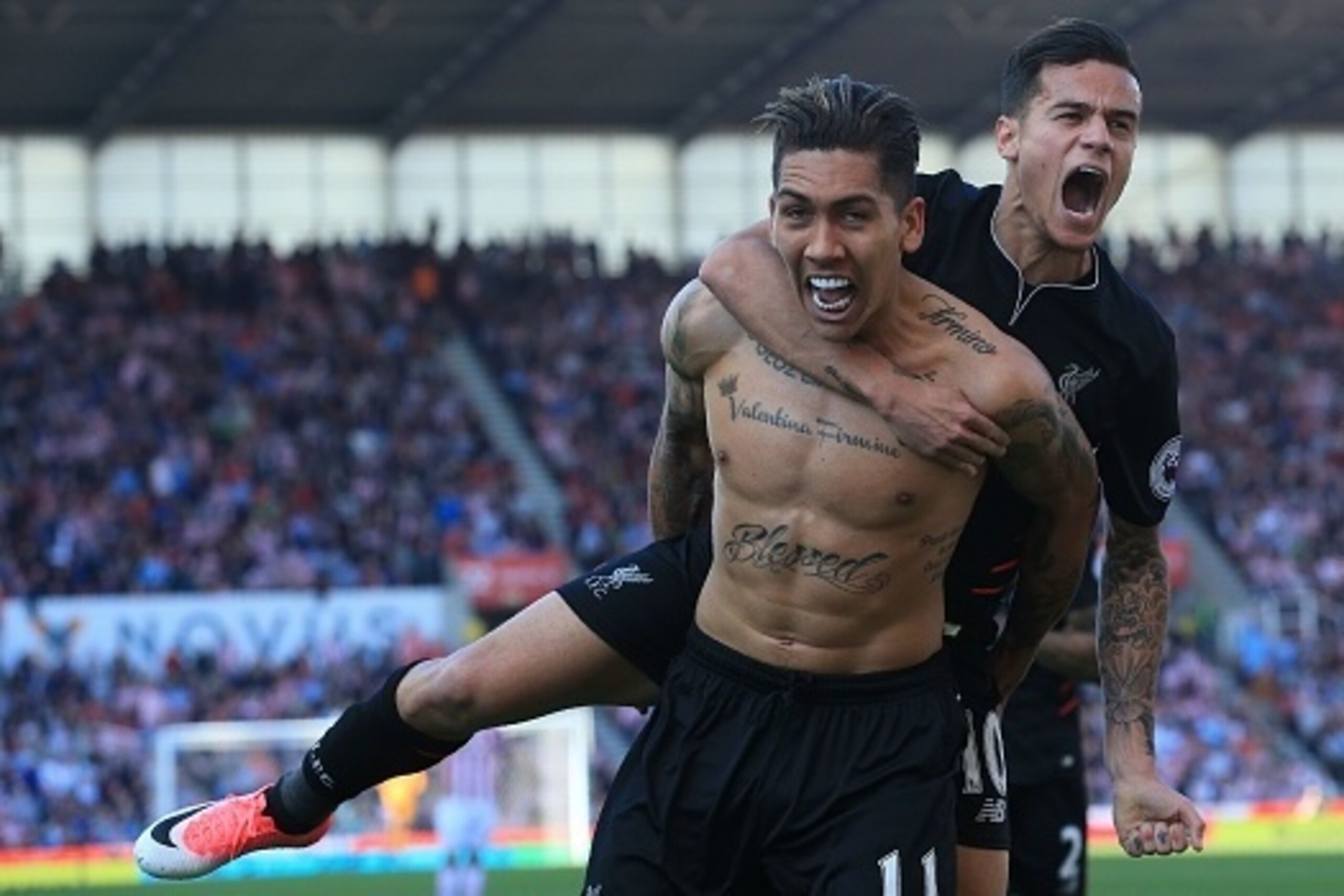 Liverpool's Brazilian midfielder Roberto Firmino (L) celebrates scoring his team's second goal with Liverpool's Brazilian midfielder Philippe Coutinho during the English Premier League football match between Stoke City and Liverpool at the Bet365 Stadium 