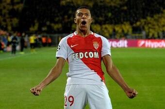 TOPSHOT - Monaco's French forward Kylian Mbappe Lottin reacs after scoring during the UEFA Champions League 1st leg quarter-final football match BVB Borussia Dortmund v Monaco in Dortmund, western Germany on April 12, 2017.
The match had been postponed af