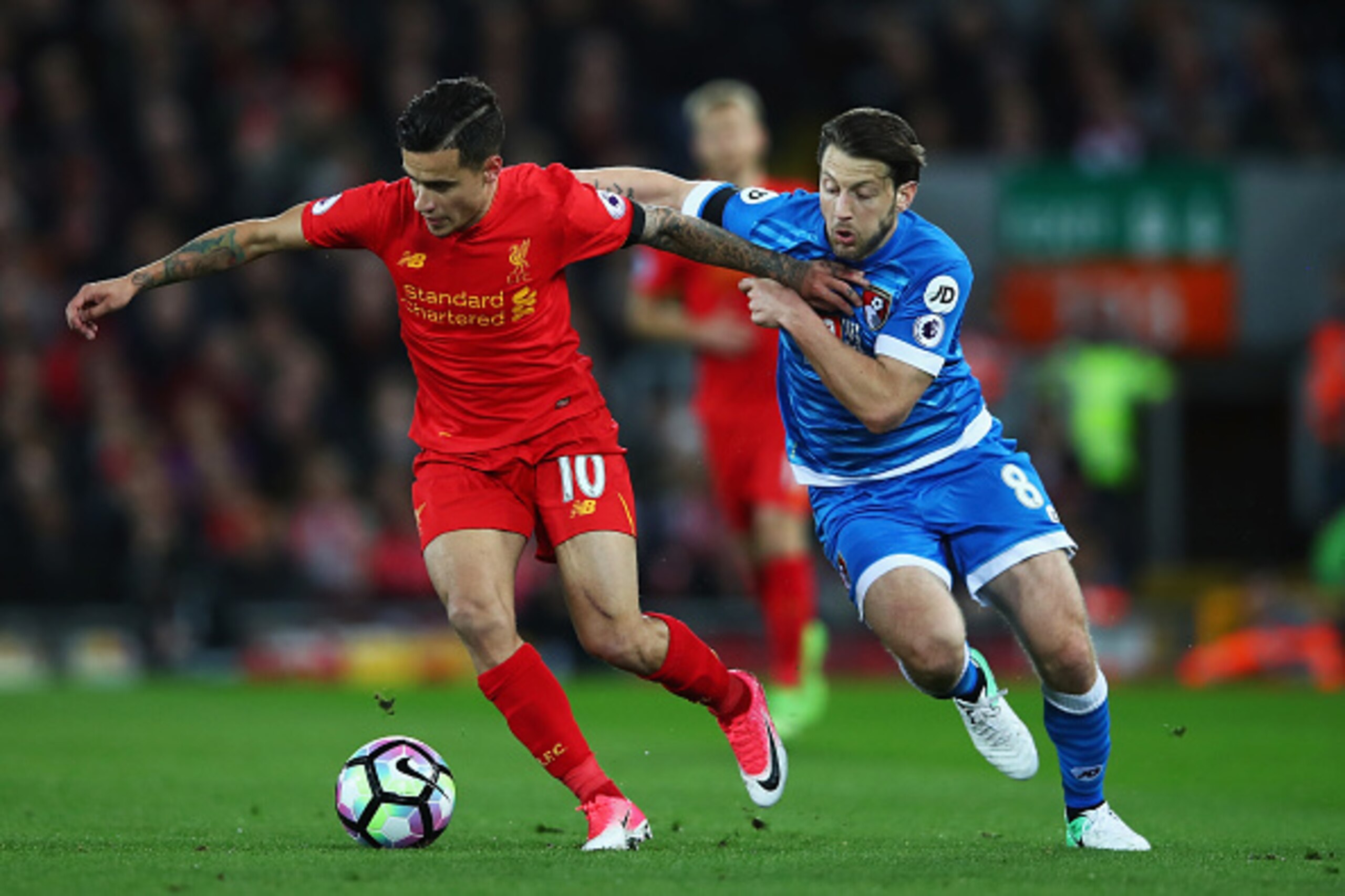 LIVERPOOL, ENGLAND - APRIL 05:  Philippe Coutinho of Liverpool (L) and Harry Arter of AFC Bournemouth (R) battle for possession during the Premier League match between Liverpool and AFC Bournemouth at Anfield on April 5, 2017 in Liverpool, England.  (Phot