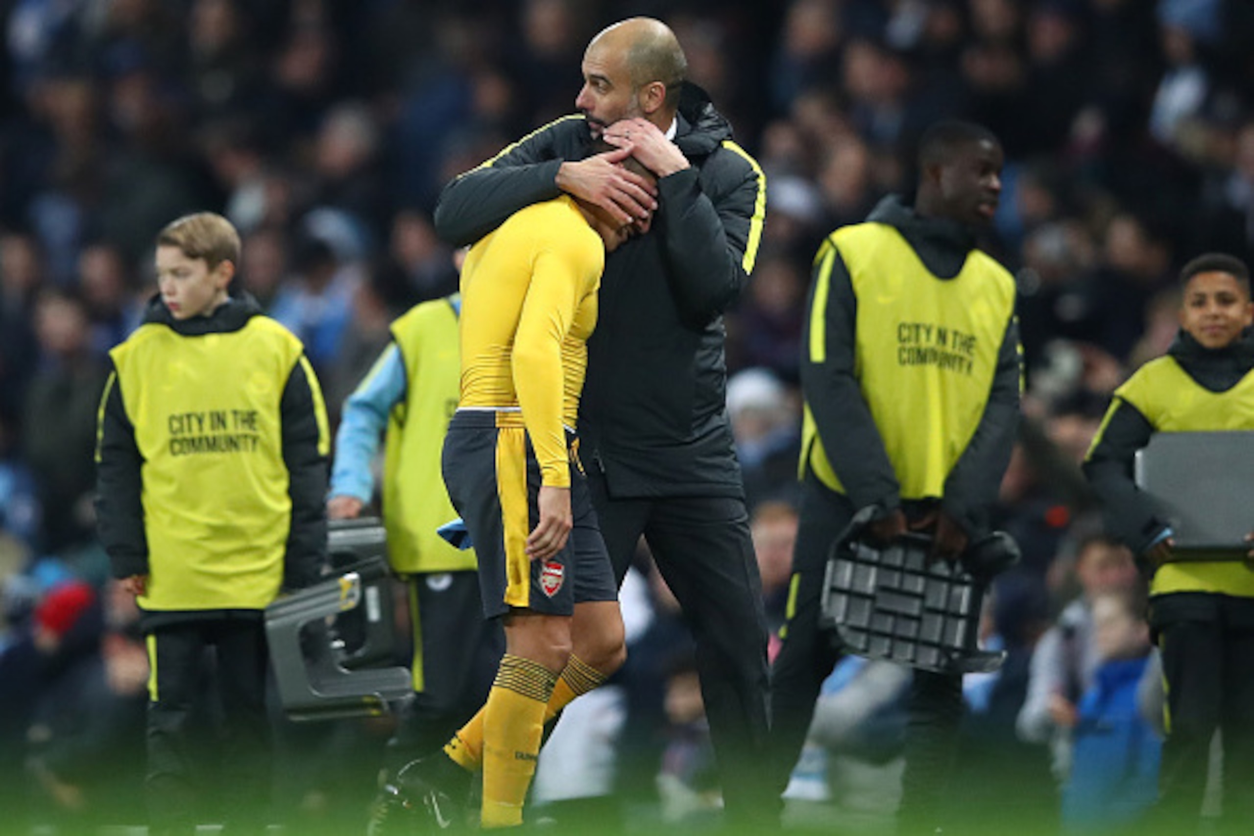 MANCHESTER, ENGLAND - DECEMBER 18: Alexis Sanchez of Arsenal (L) and Josep Guardiola, Manager of Manchester City (R) embrace after the final whistle during the Premier League match between Manchester City and Arsenal at the Etihad Stadium on December 18, MANCHESTER, ENGLAND - DECEMBER 18: Alexis Sanchez of Arsenal (L) and Josep Guardiola, Manager of Manchester City (R) embrace after the final whistle during the Premier League match between Manchester City and Arsenal at the Etihad Stadium on December 18,