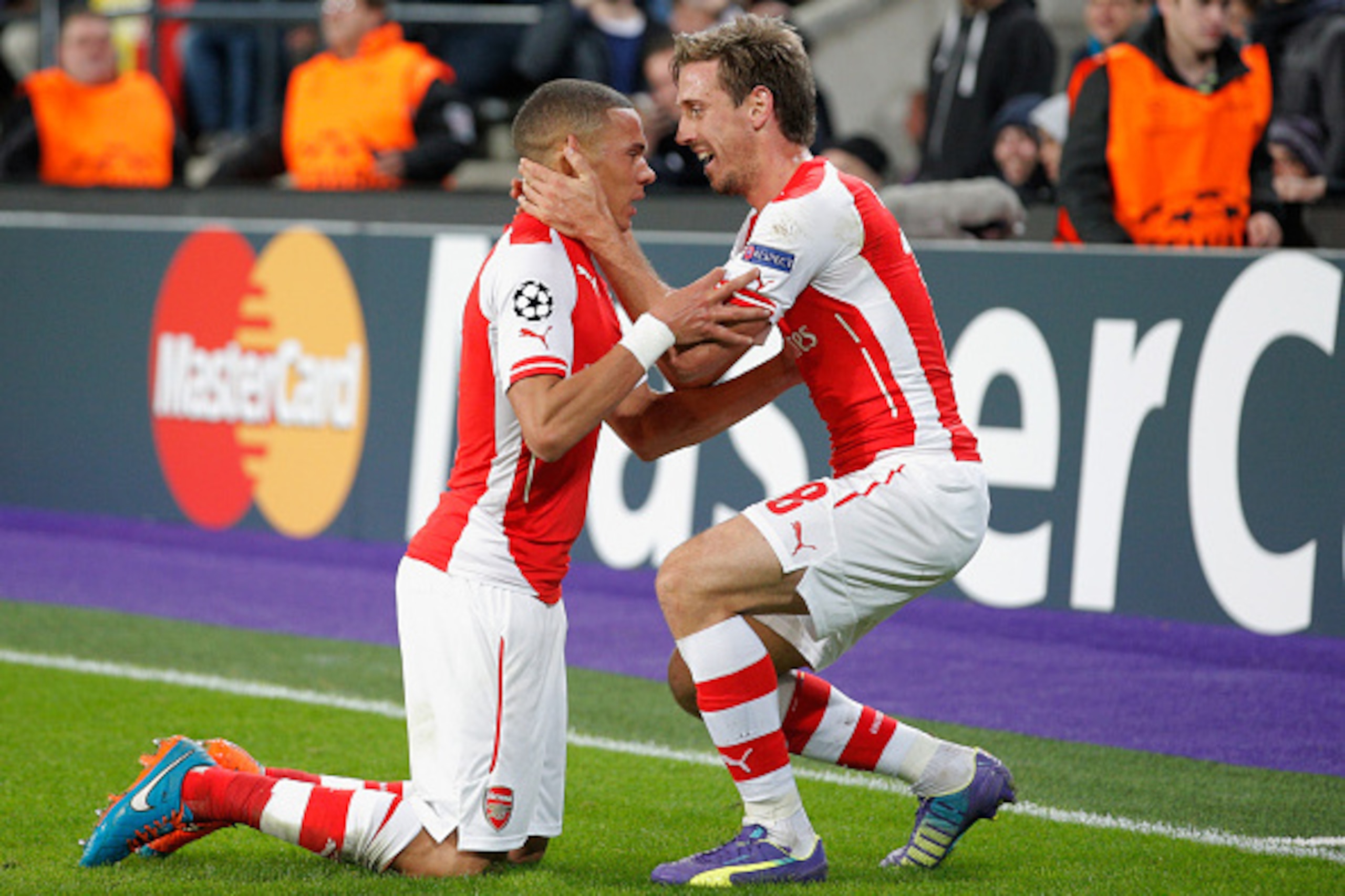 BRUSSELS, BELGIUM - OCTOBER 22:  Kieran Gibbs of Arsenal (L) celebrates with team mate Nacho Monreal as he scores their first and equalising goal during the UEFA Champions League Group D match between RSC Anderlecht and Arsenal at Constant Vanden Stock St